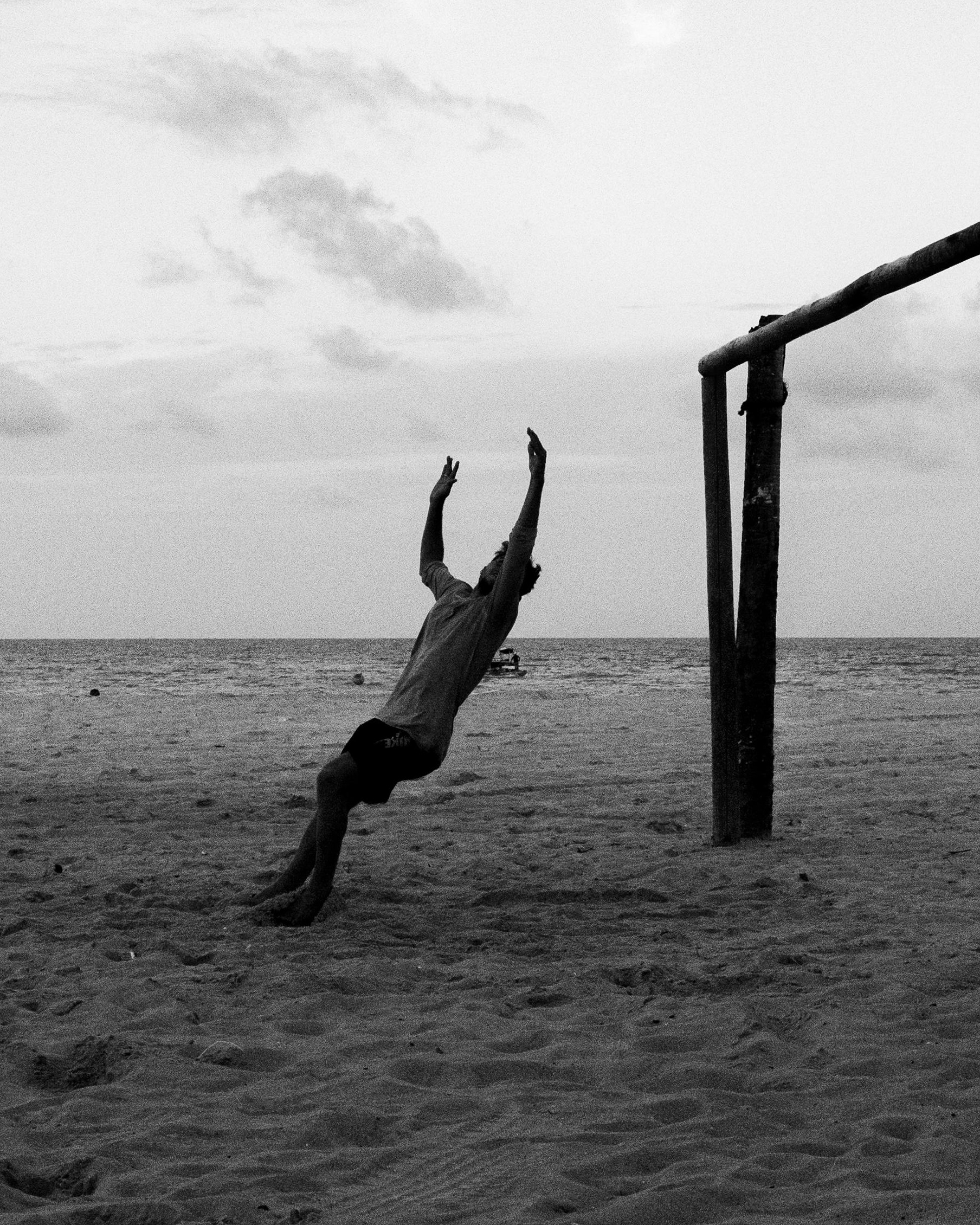 Person Jumping for Volleyball at Beach