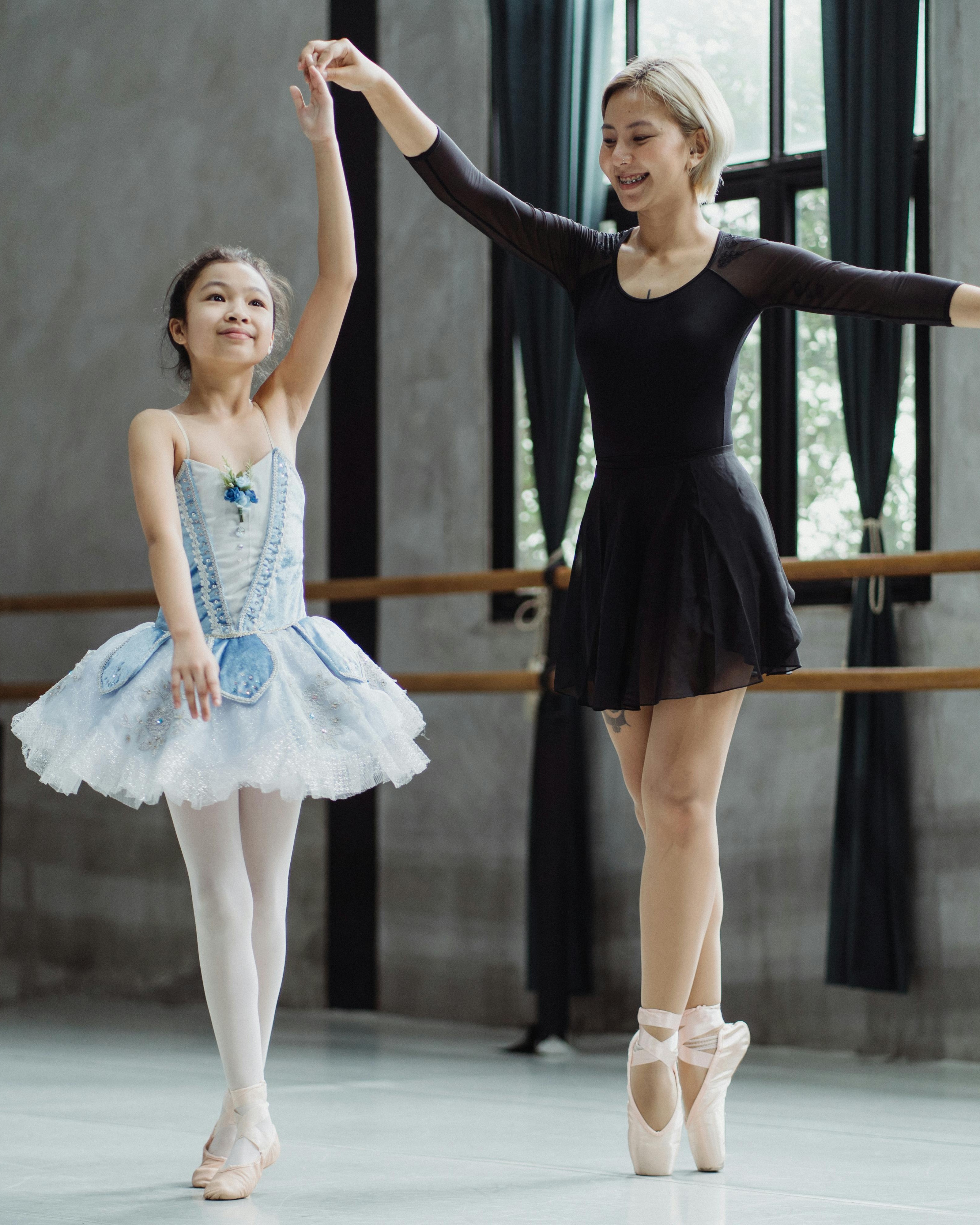 Ballet Teacher Guiding Young Student