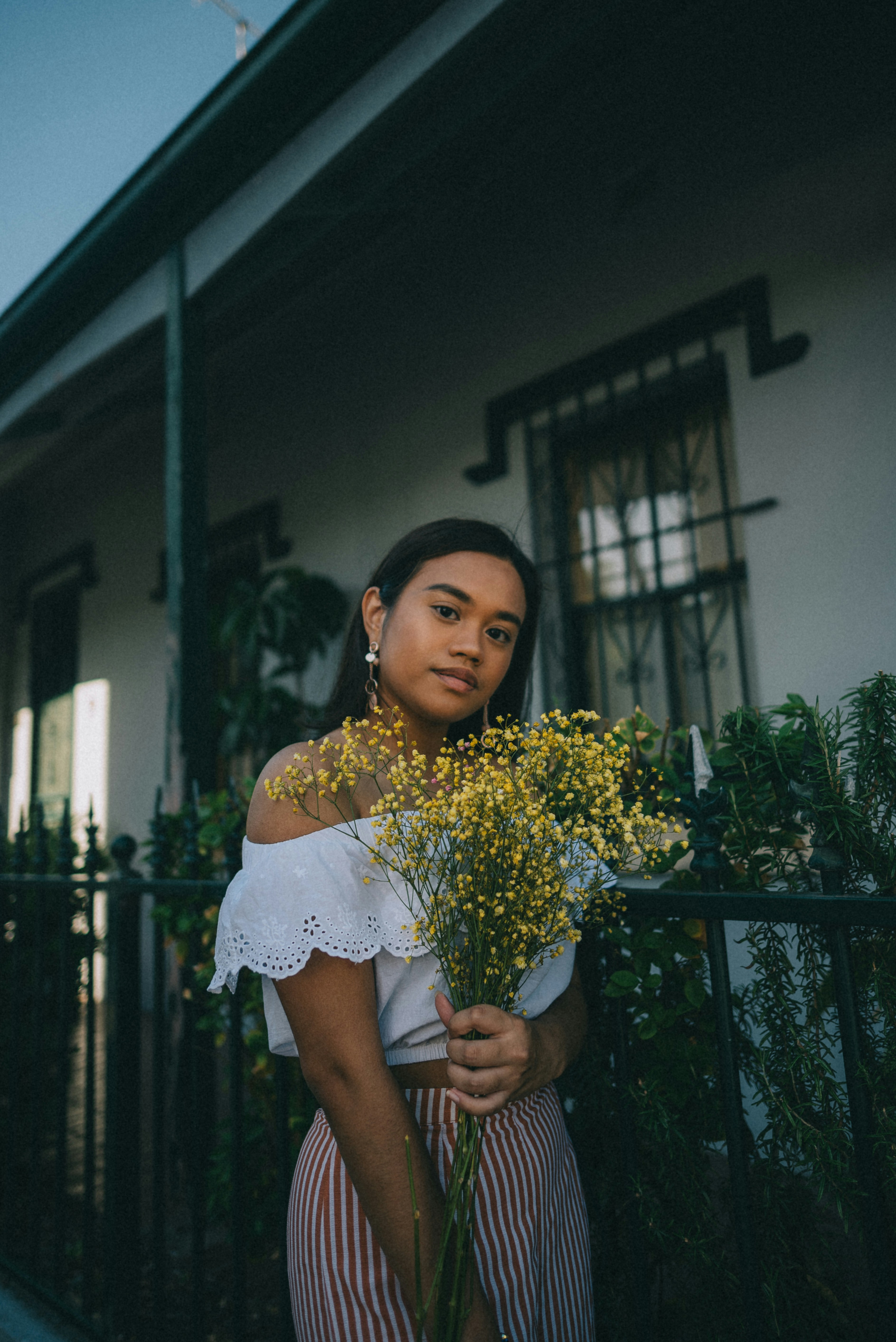Woman holding yellow wildflowers
