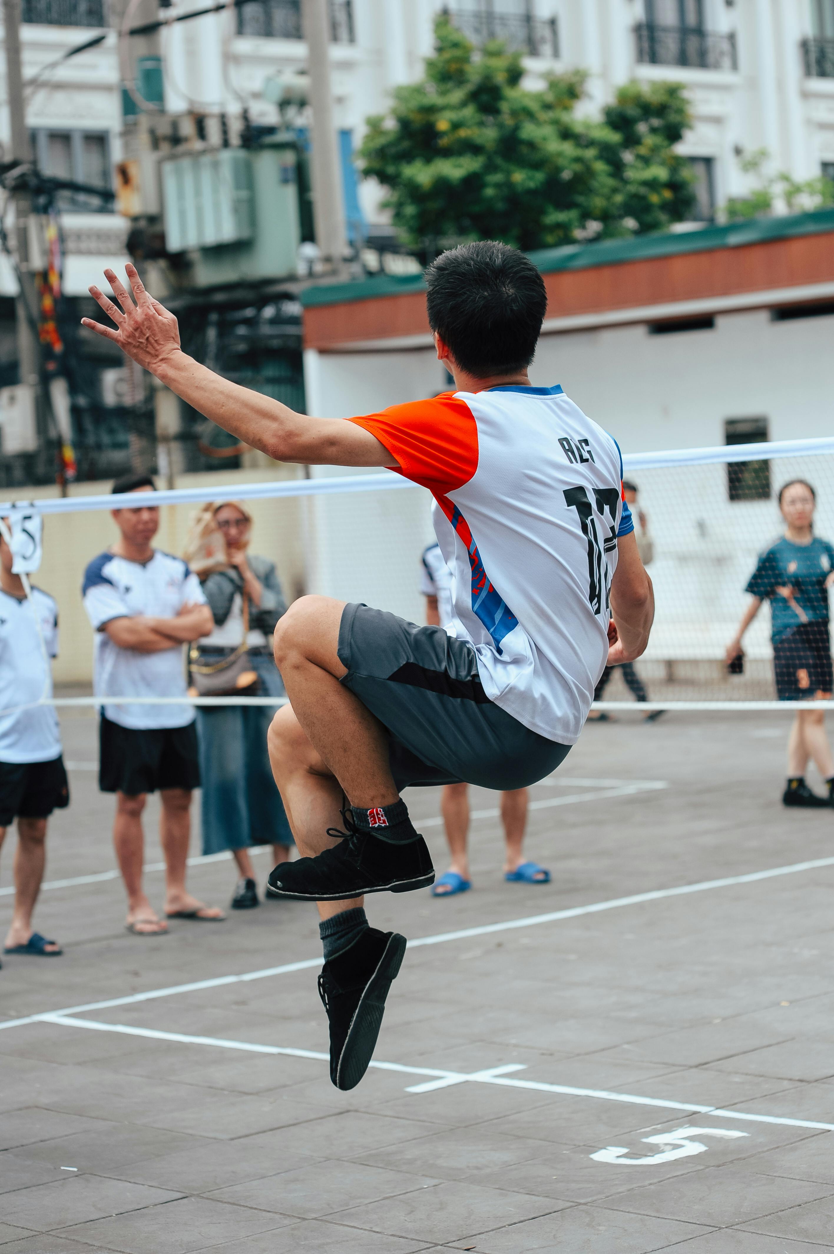Jumping Volleyball Player on Outdoor Court