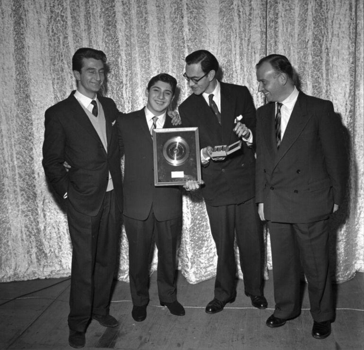 Four Men Receiving Gold Record Award