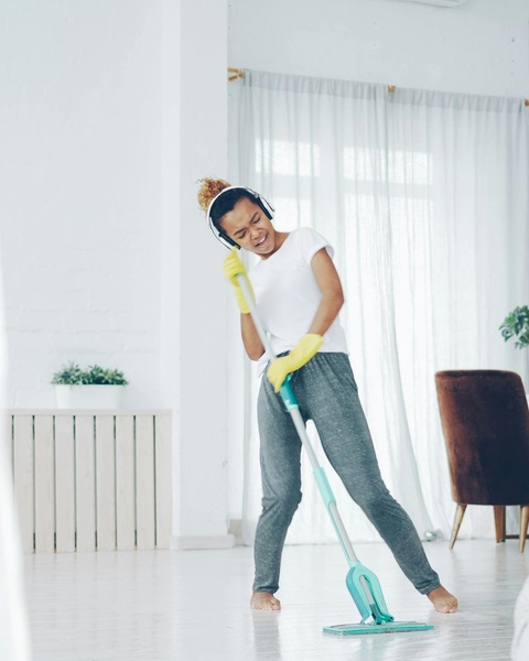 Woman Mopping While Listening to Music