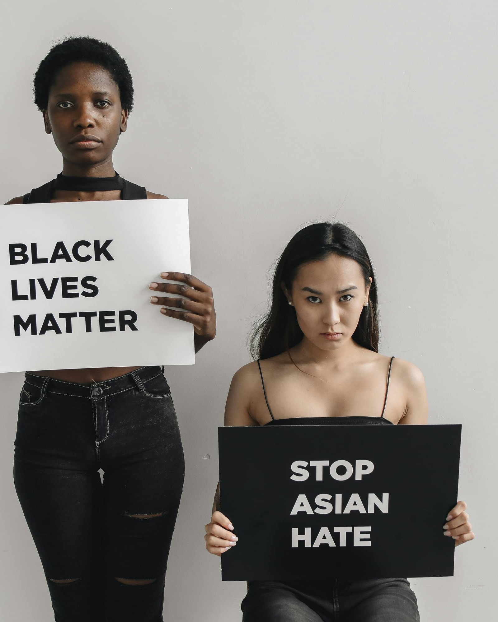 Two Activists Holding Solidarity Protest Signs