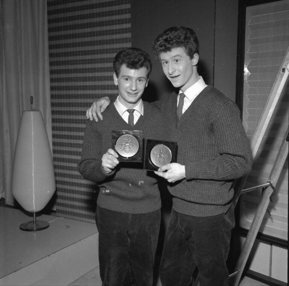 Two Young Men Holding Award Medals