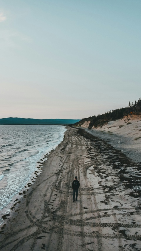 Lone Person Walking on Beach