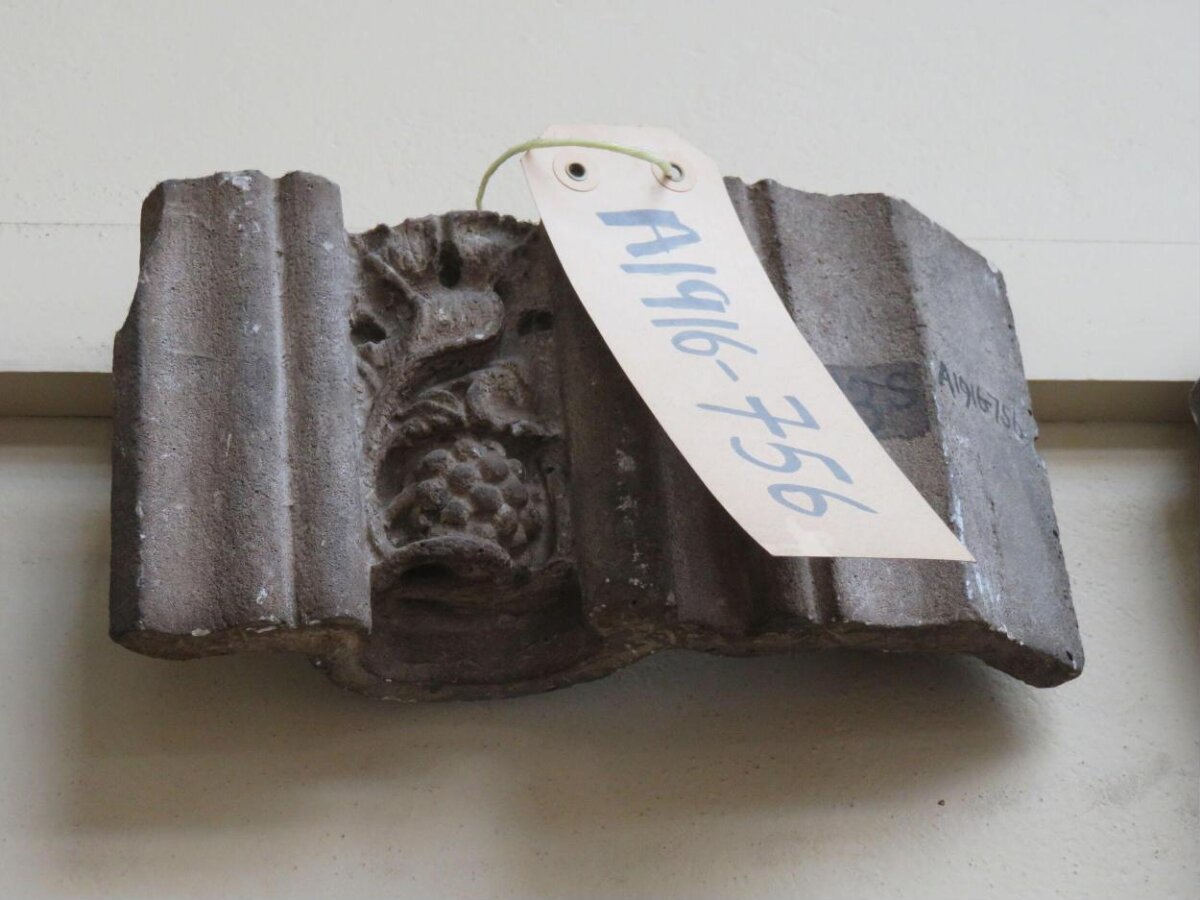 Carved Stone Fragment with Museum Tag
