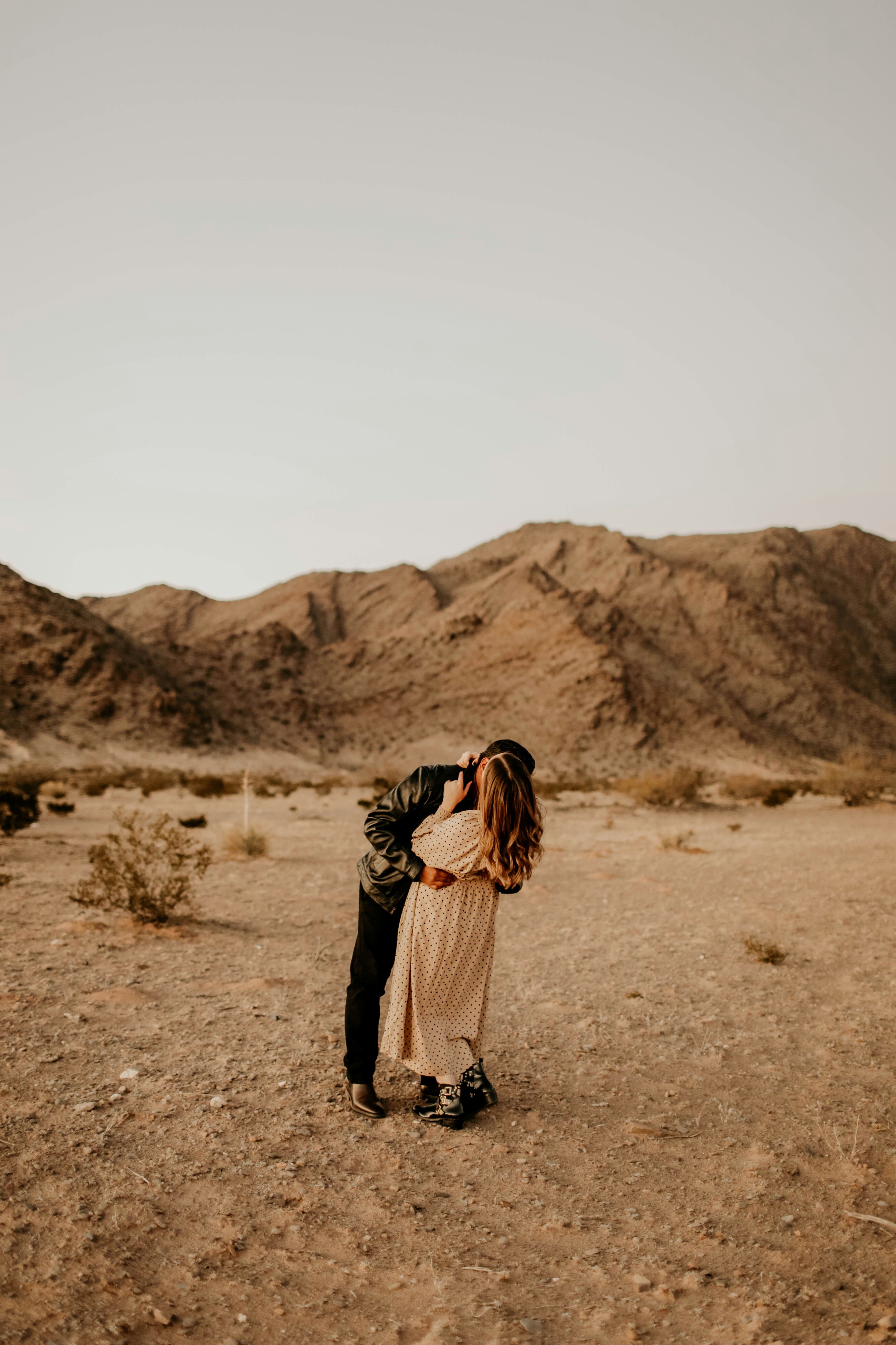 Couple Embracing In Desert
