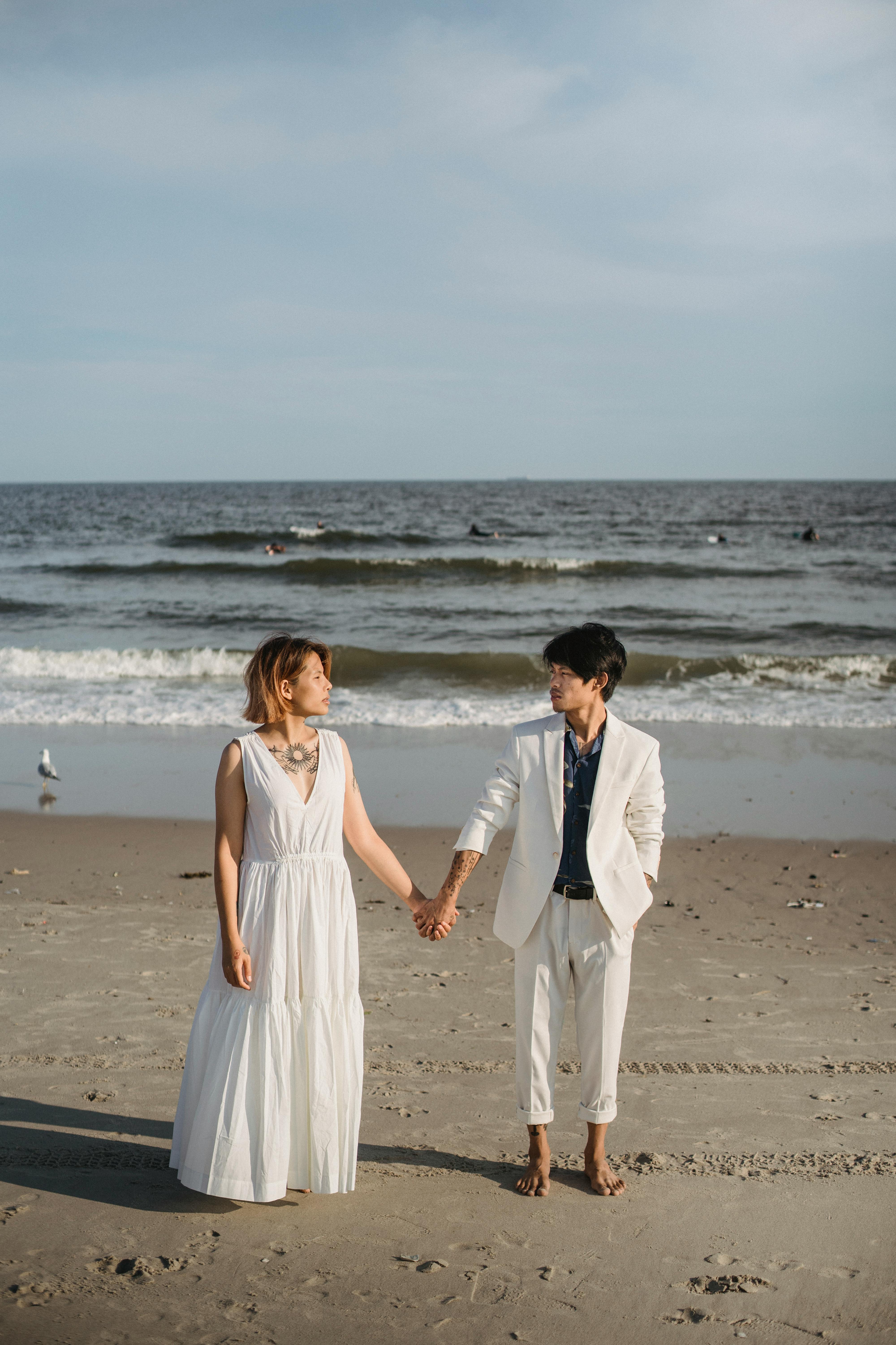Couple Holding Hands on Beach