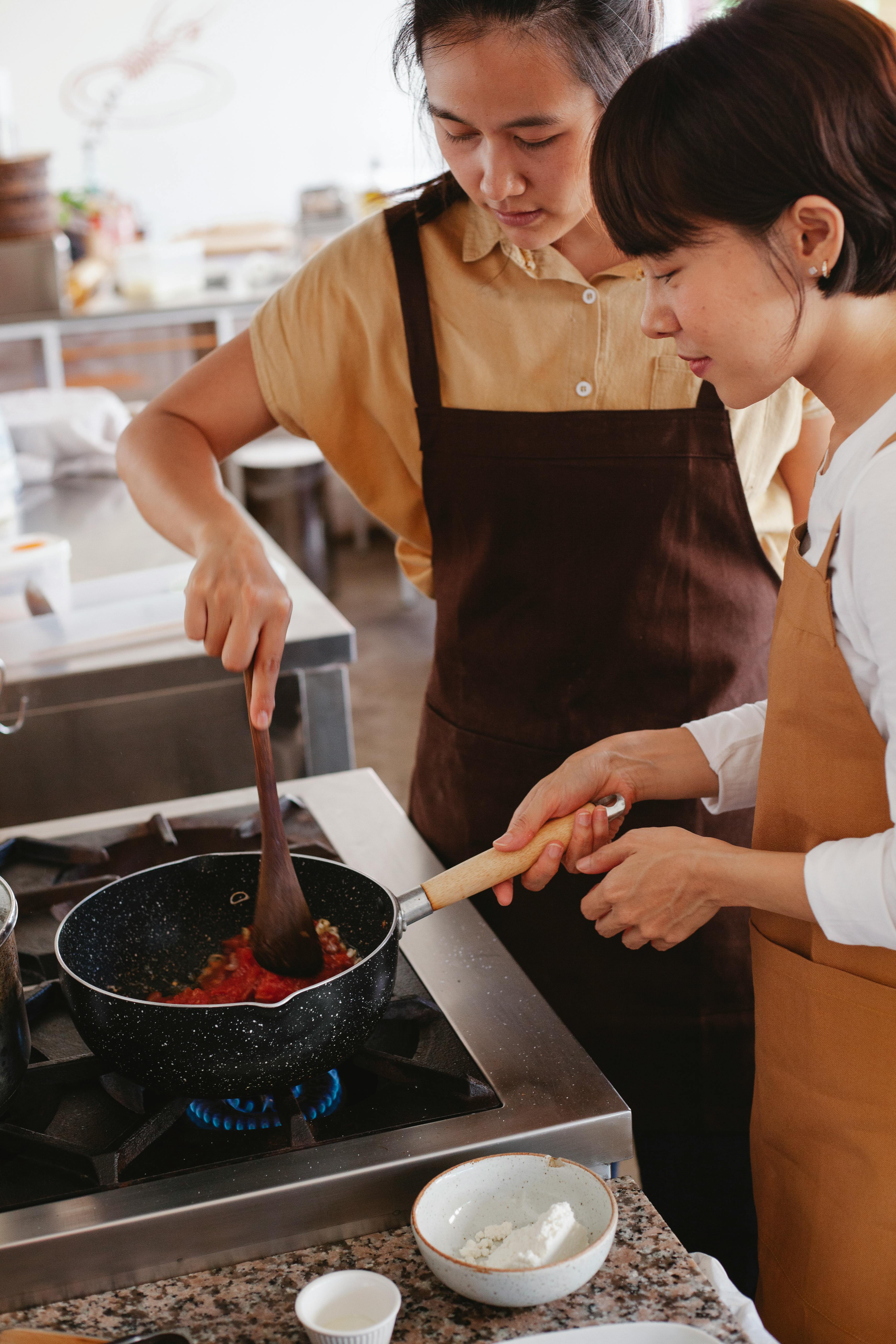 Two Women Cooking Together in Kitchen