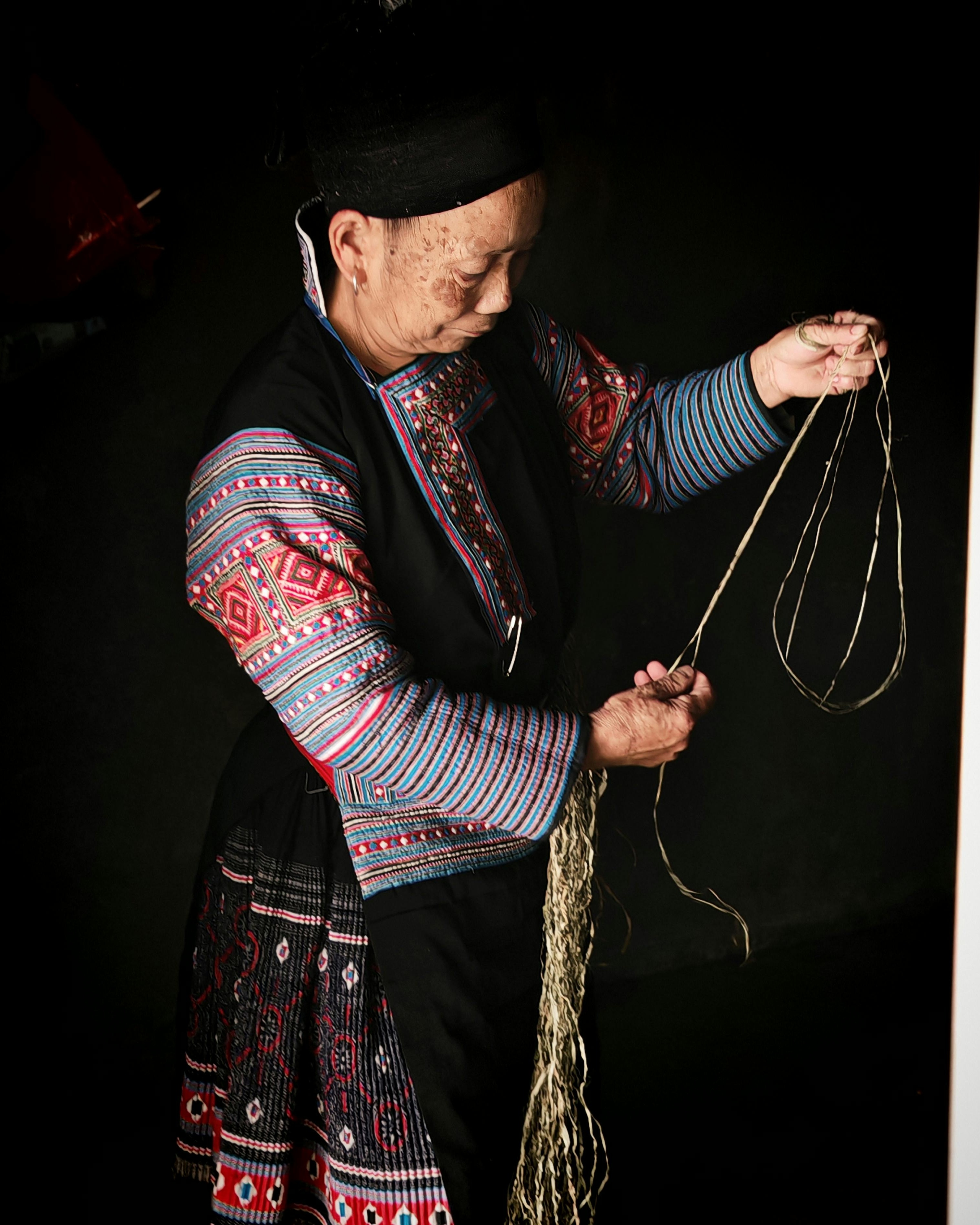 Ethnic Craftswoman Processing Hemp Threads