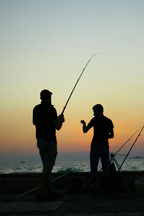 Two Men Fishing at Sunset