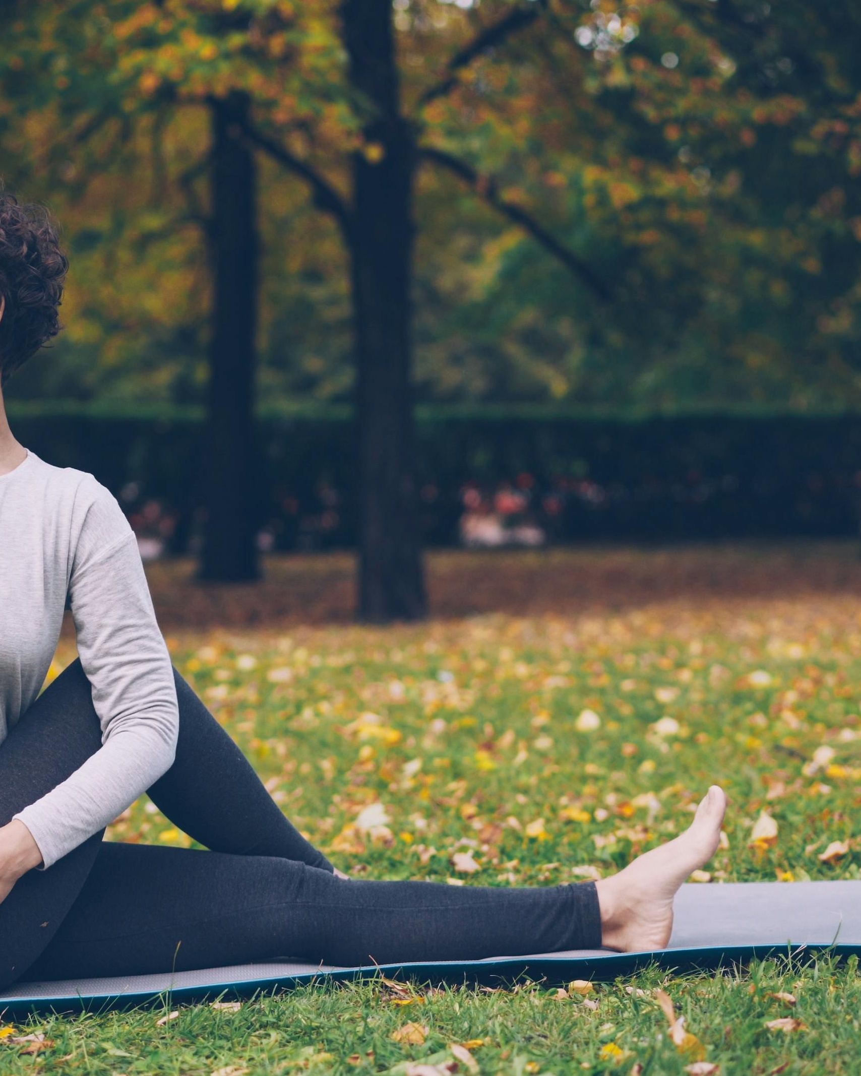 Woman Doing Yoga in Autumn Park