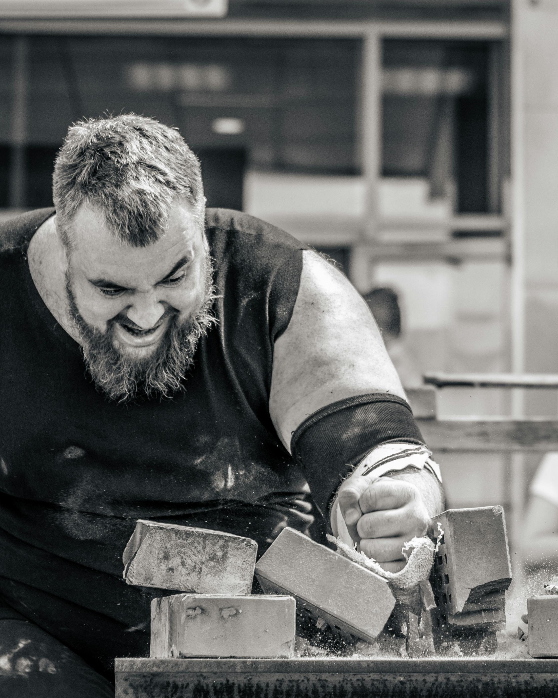 Strongman Breaking Concrete Bricks