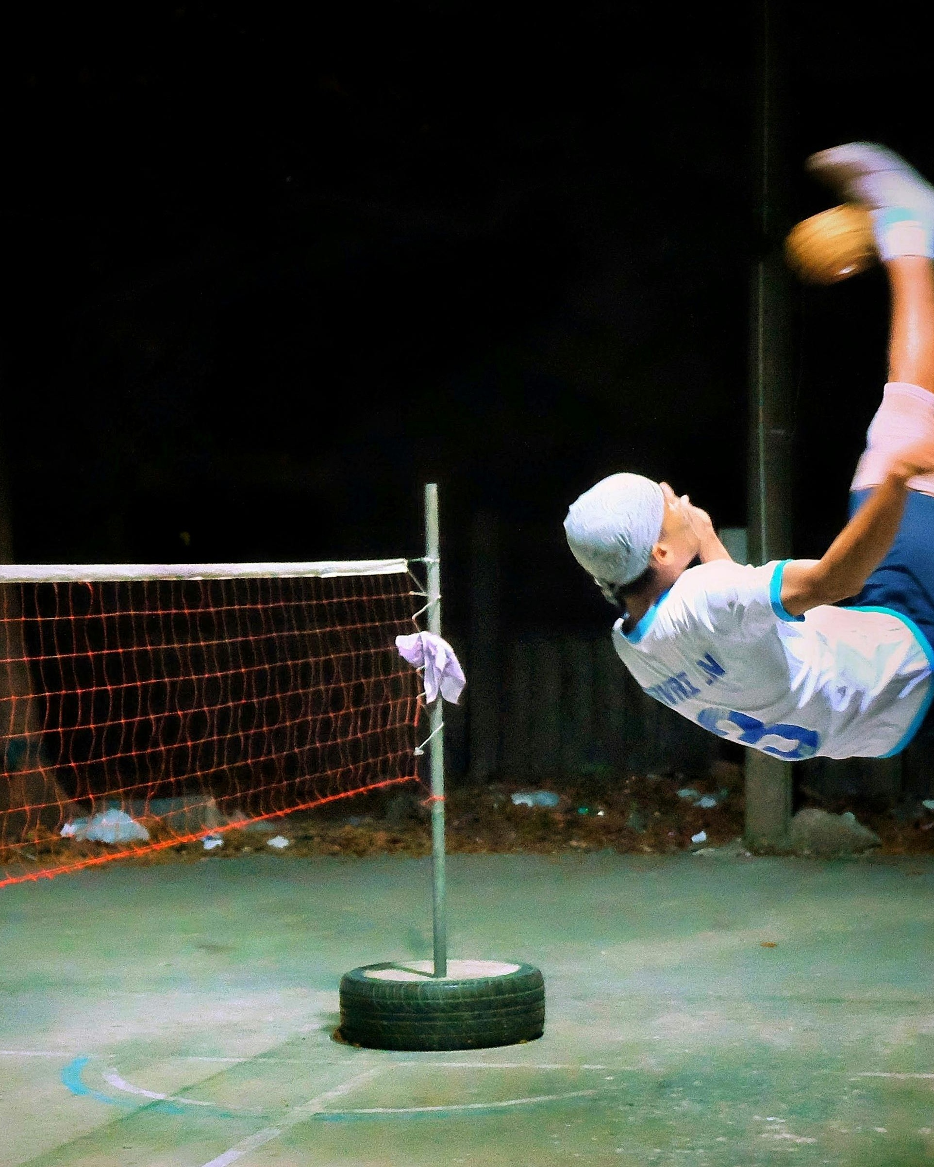 Sepak Takraw Player Bicycle Kick at Night