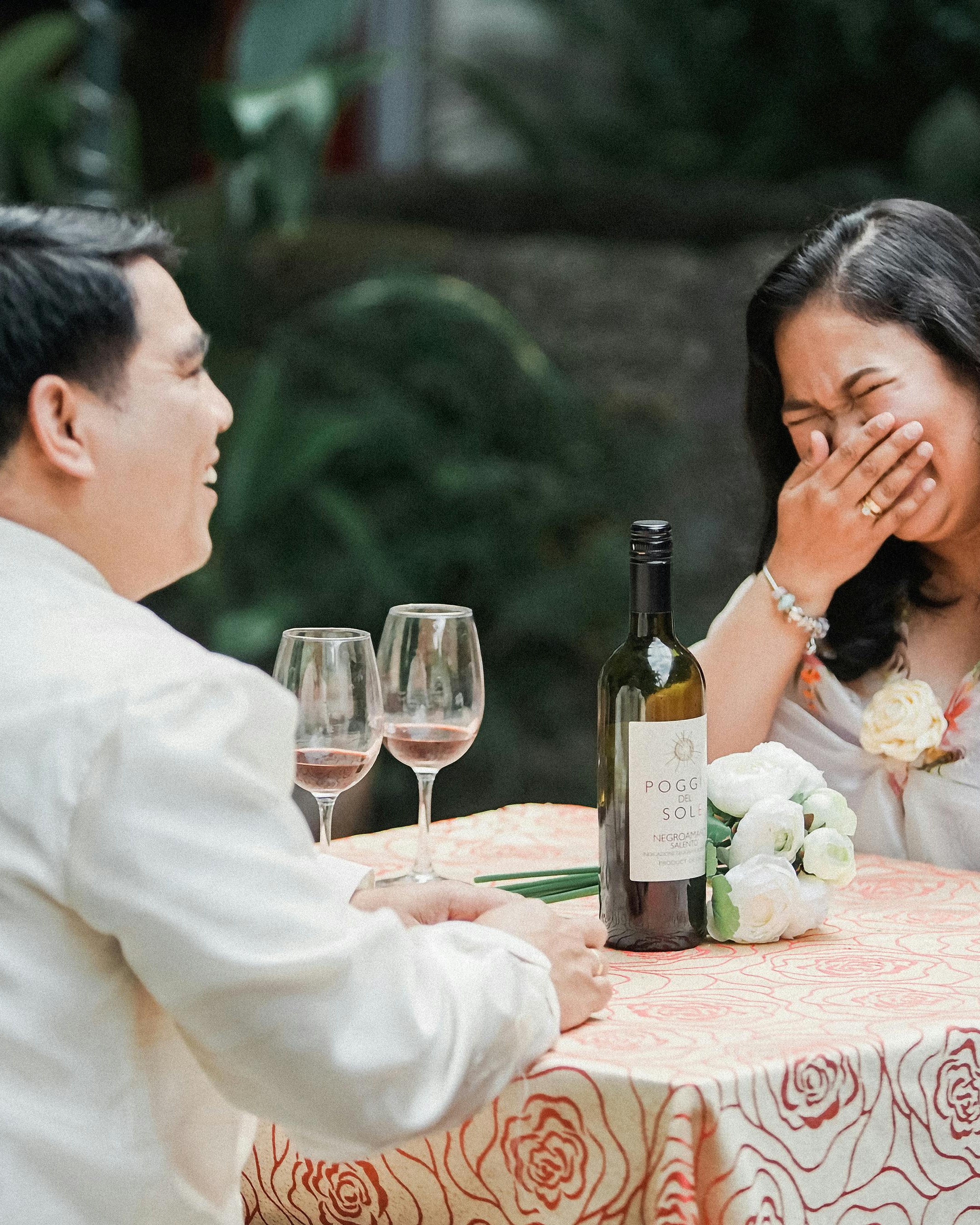 Couple Laughing At Outdoor Wine Date