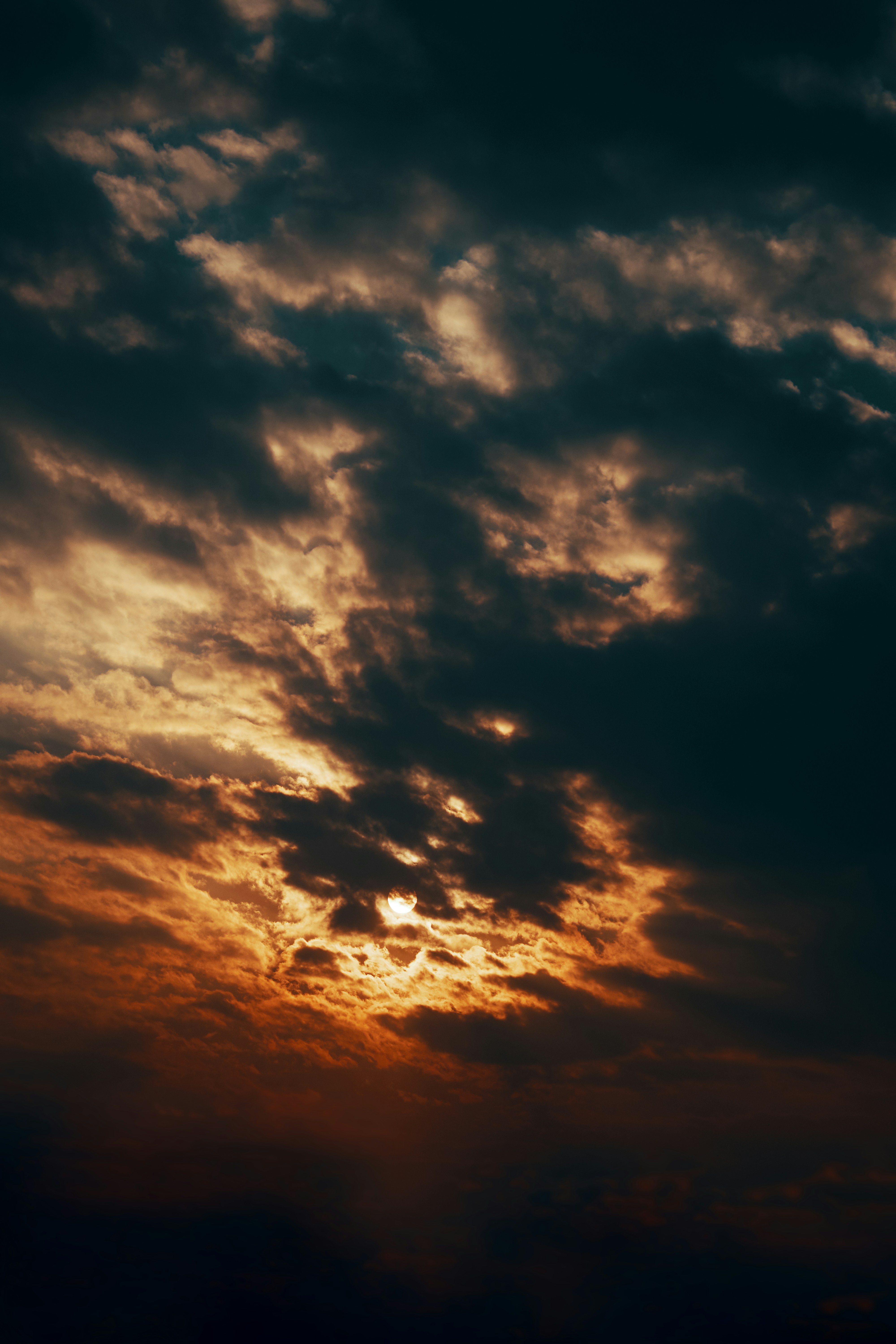 Sun Peeking Through Cloudy Sunset Sky