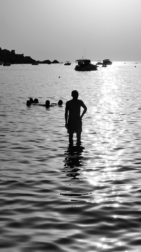 Silhouetted People in the Sea