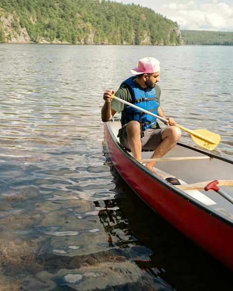 Man Canoeing on Calm Lake