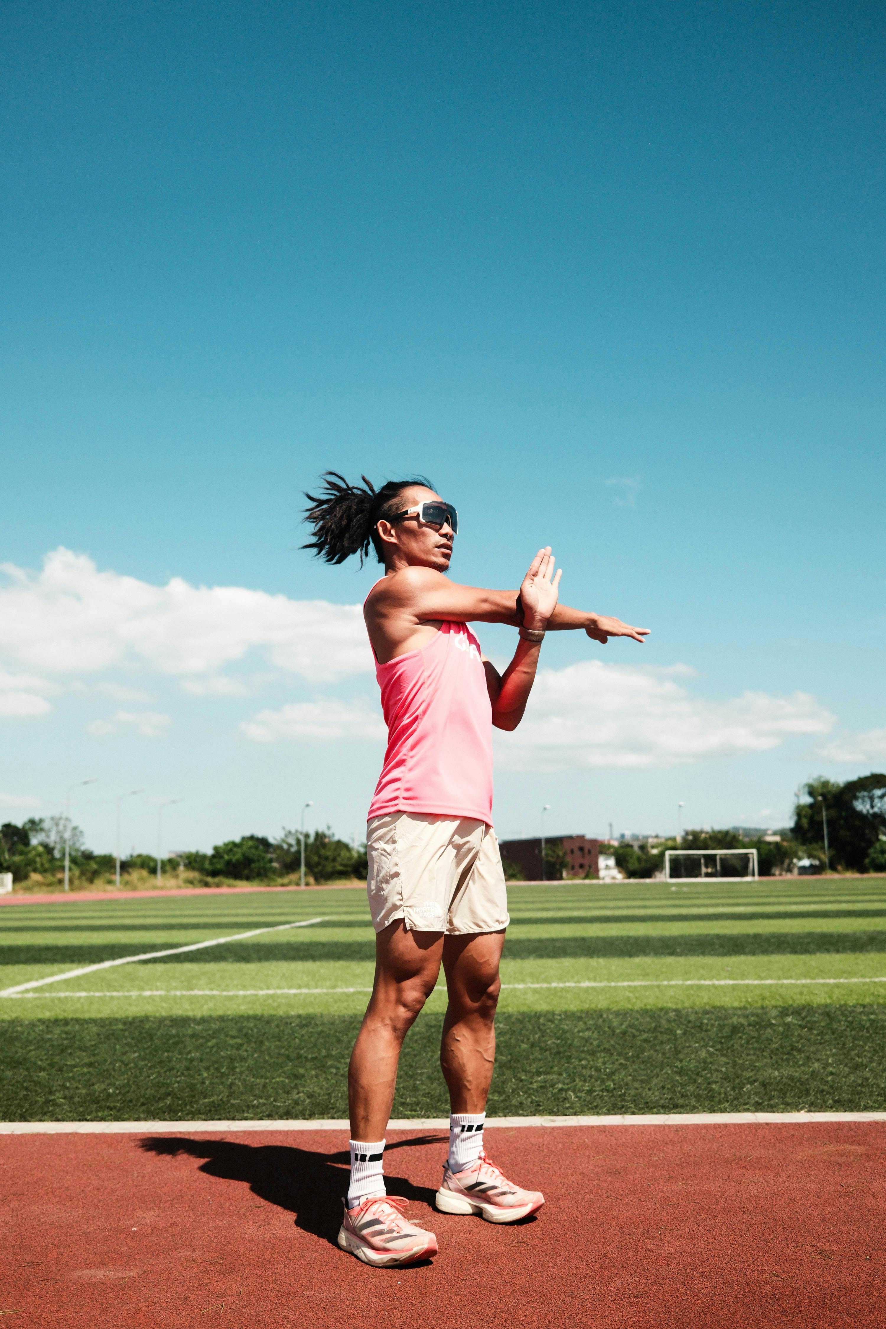 Runner Stretching on Outdoor Track