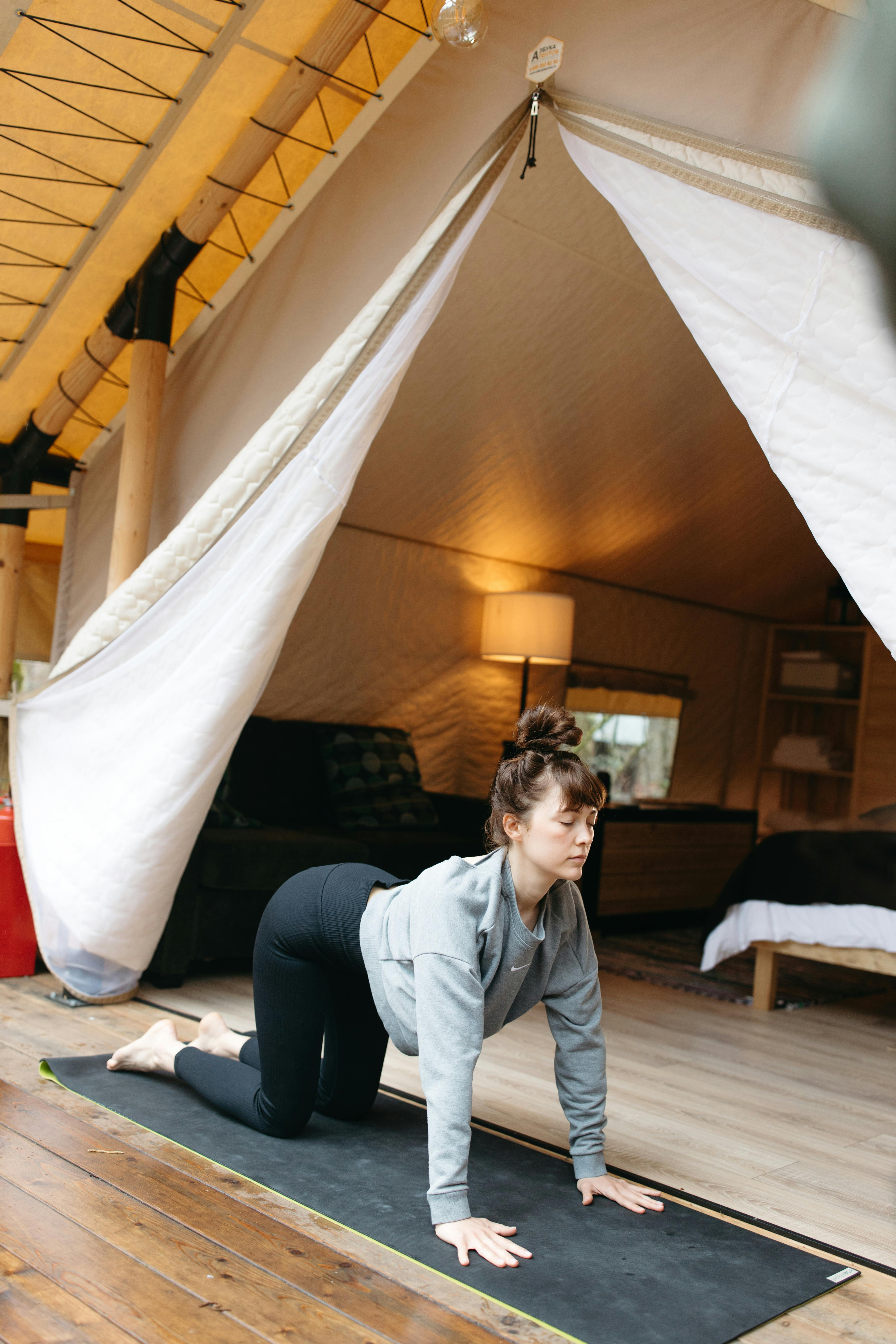 Woman Doing Yoga Inside Glamping Tent