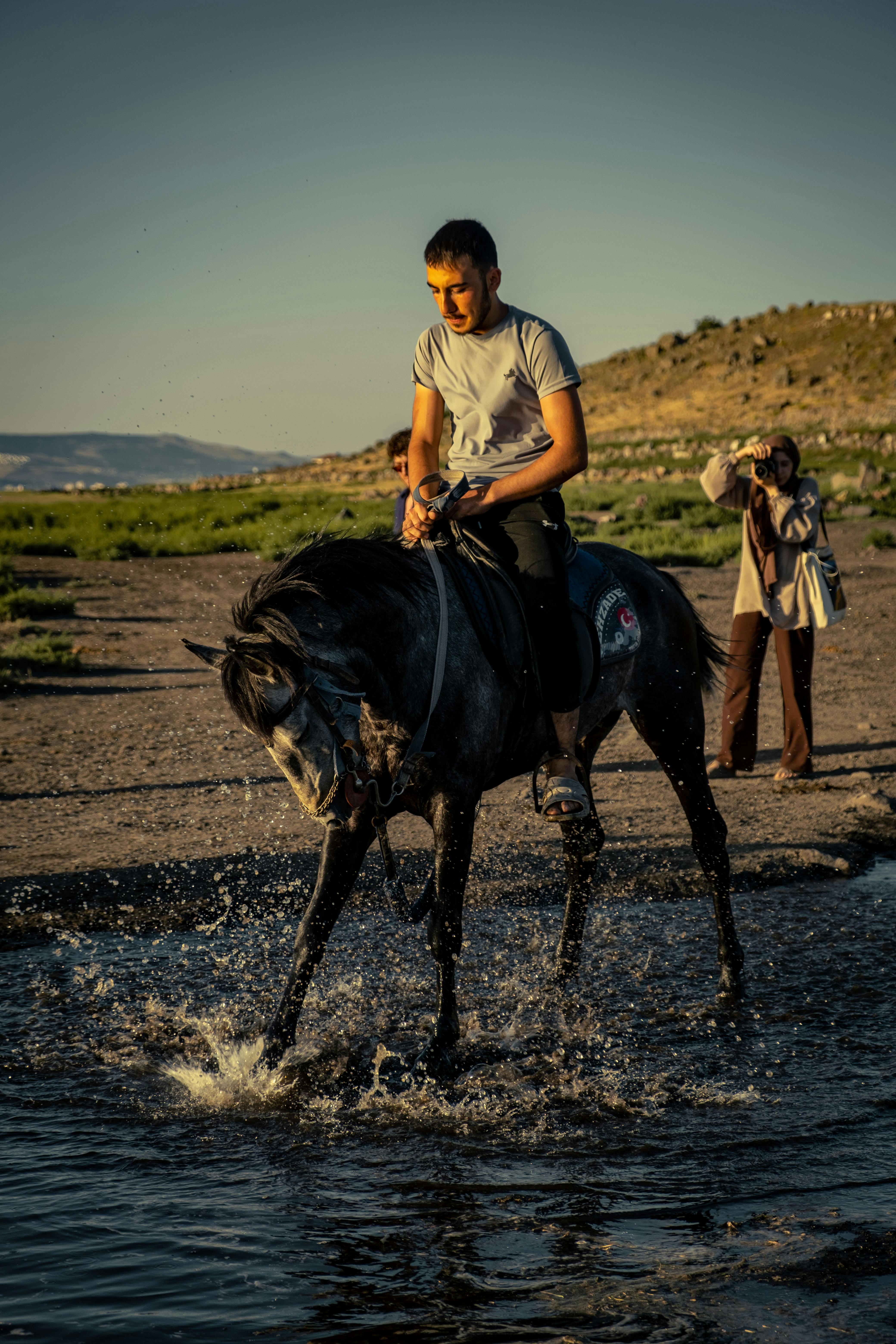 Man Riding Horse Through Shallow Water