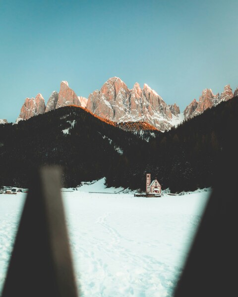 Sunlit Snowy Mountain Chapel Landscape