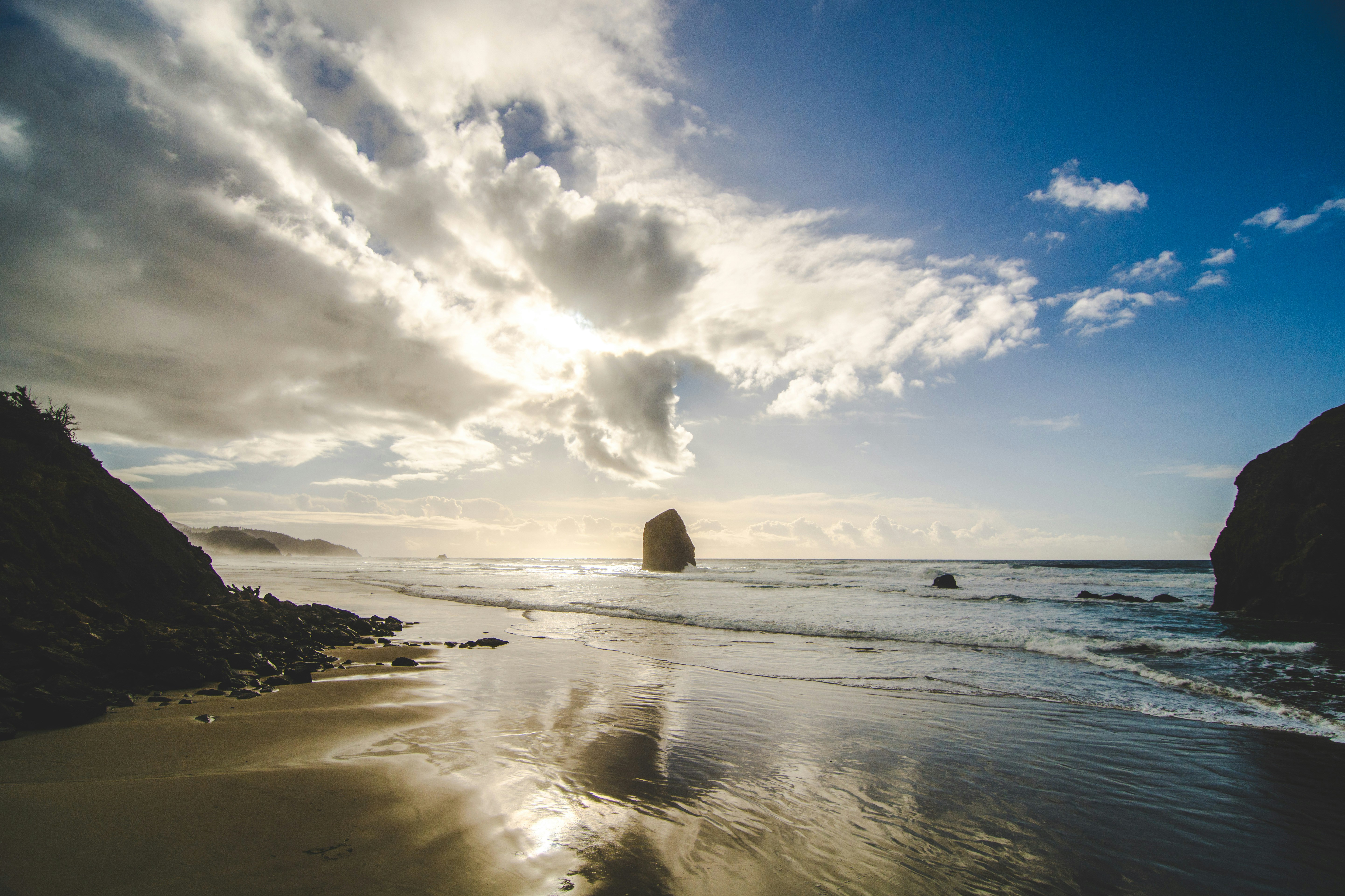 Sunlit Coastal Beach with Sea Stack