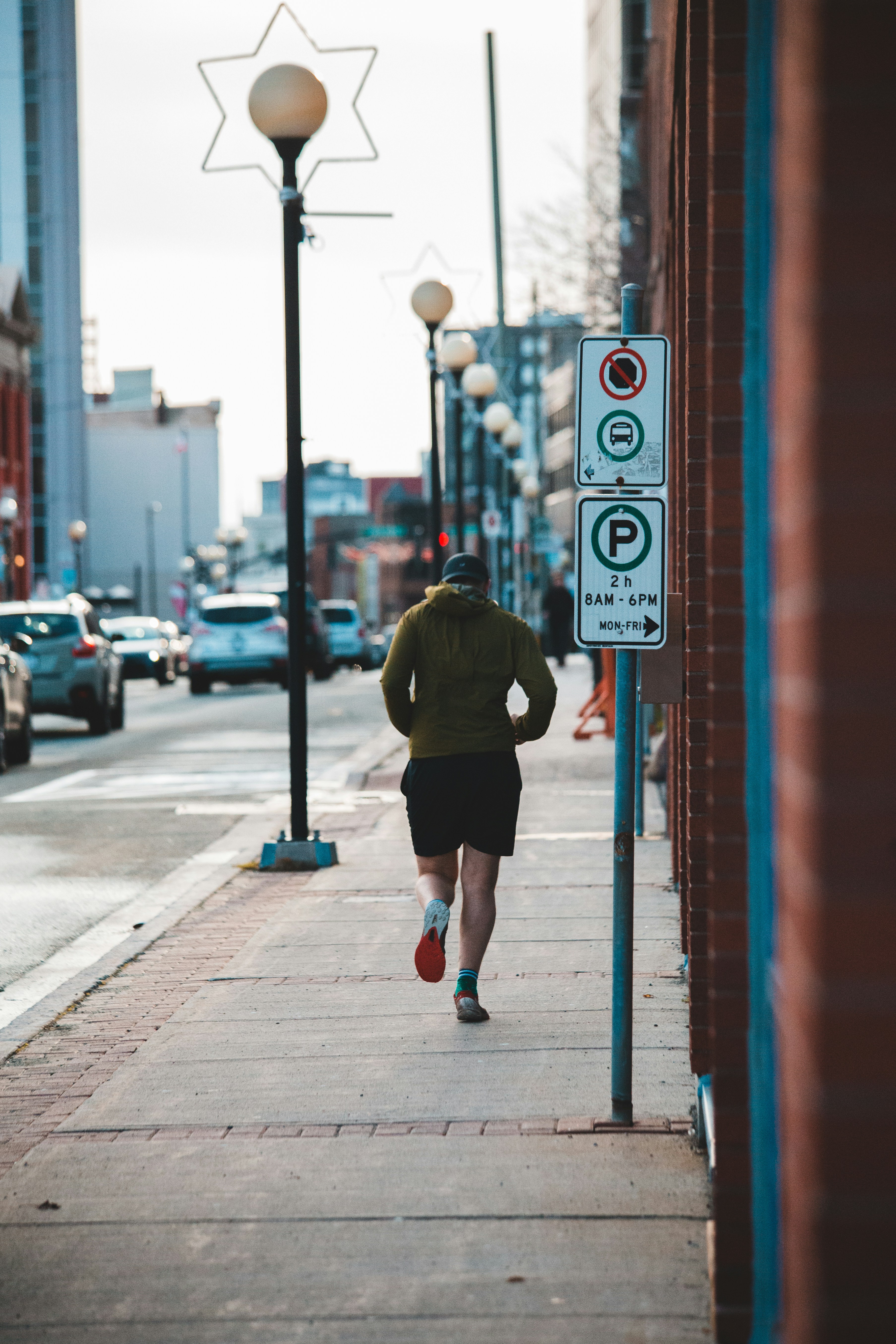 Jogger Running on Urban Sidewalk