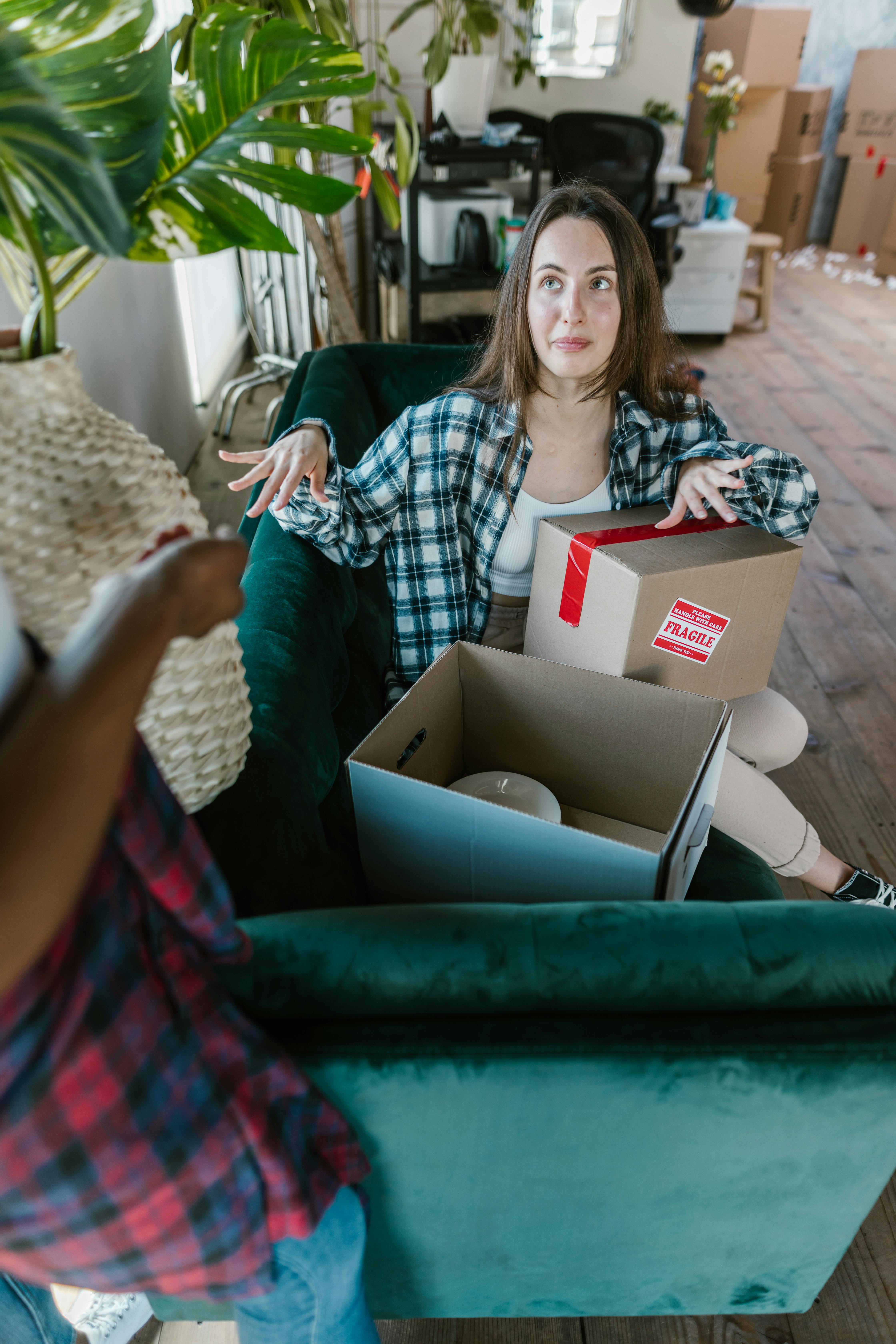 Woman Unpacking Moving Boxes in New Home