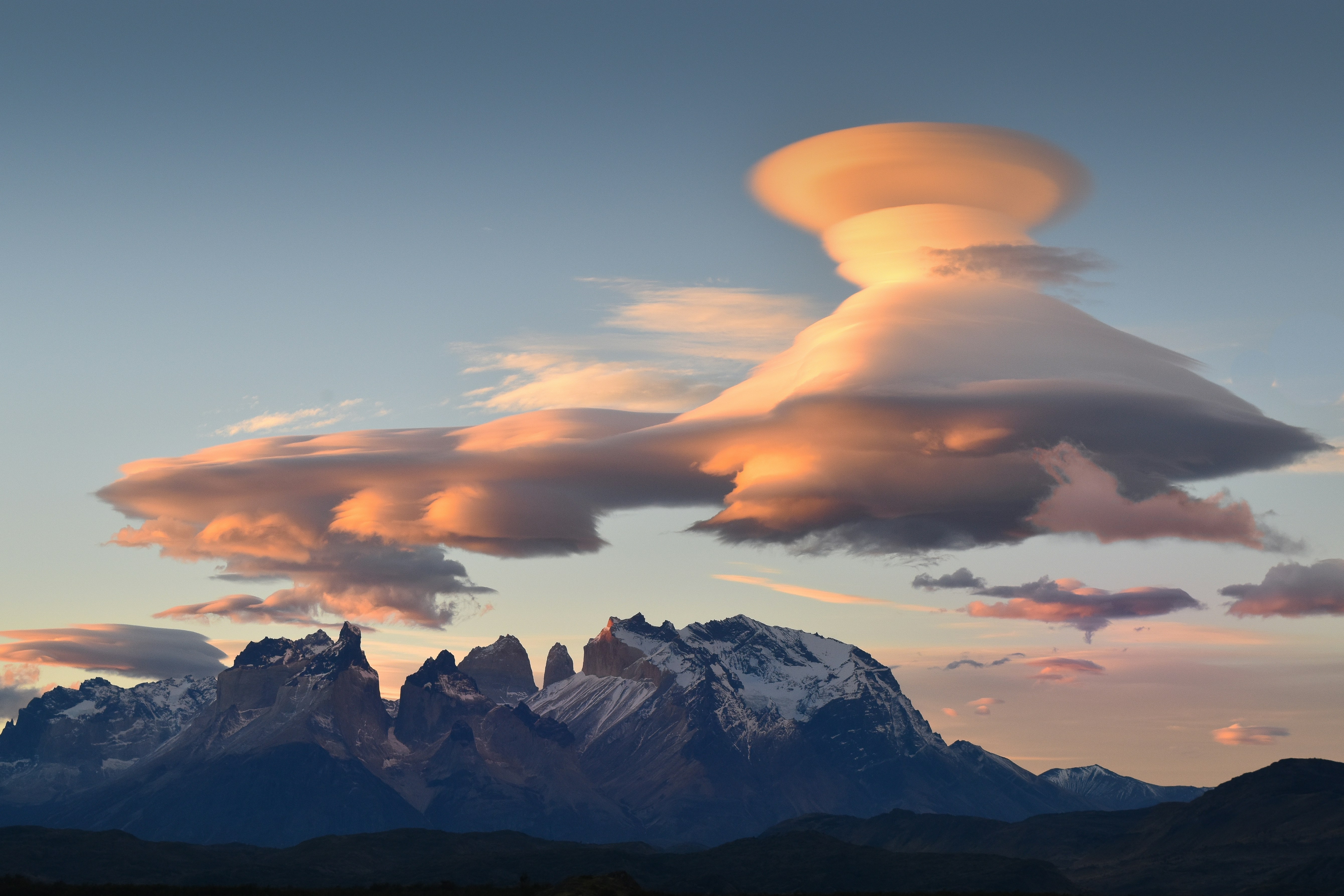 Lenticular Clouds Over Mountain Peaks