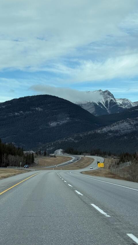 Highway Through Snow Capped Mountains