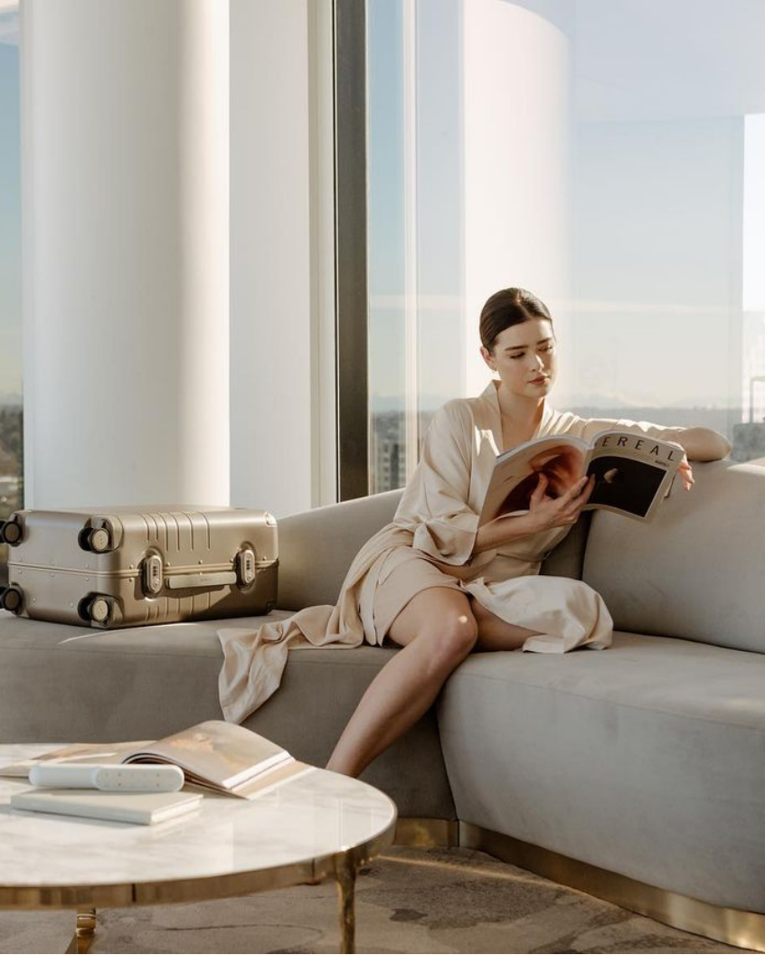 Woman Relaxing With Luxury Travel Luggage