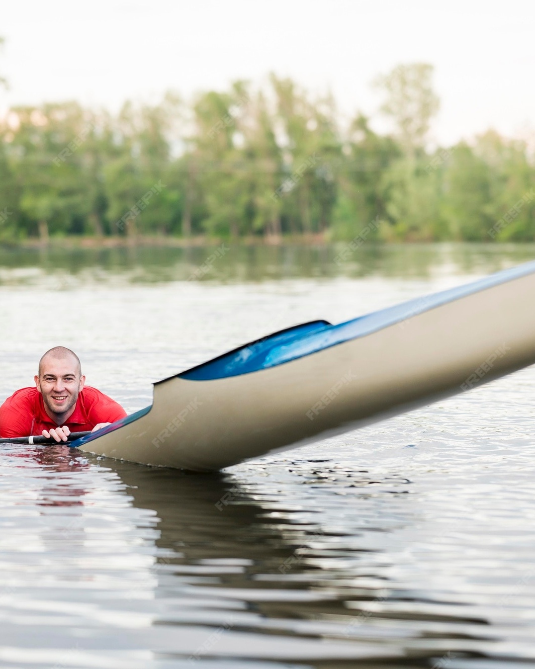 Smiling Man With Capsized Kayak On River