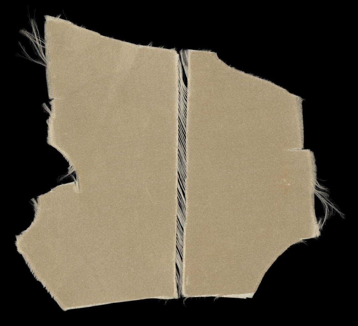 Torn Beige Fabric on Black Background