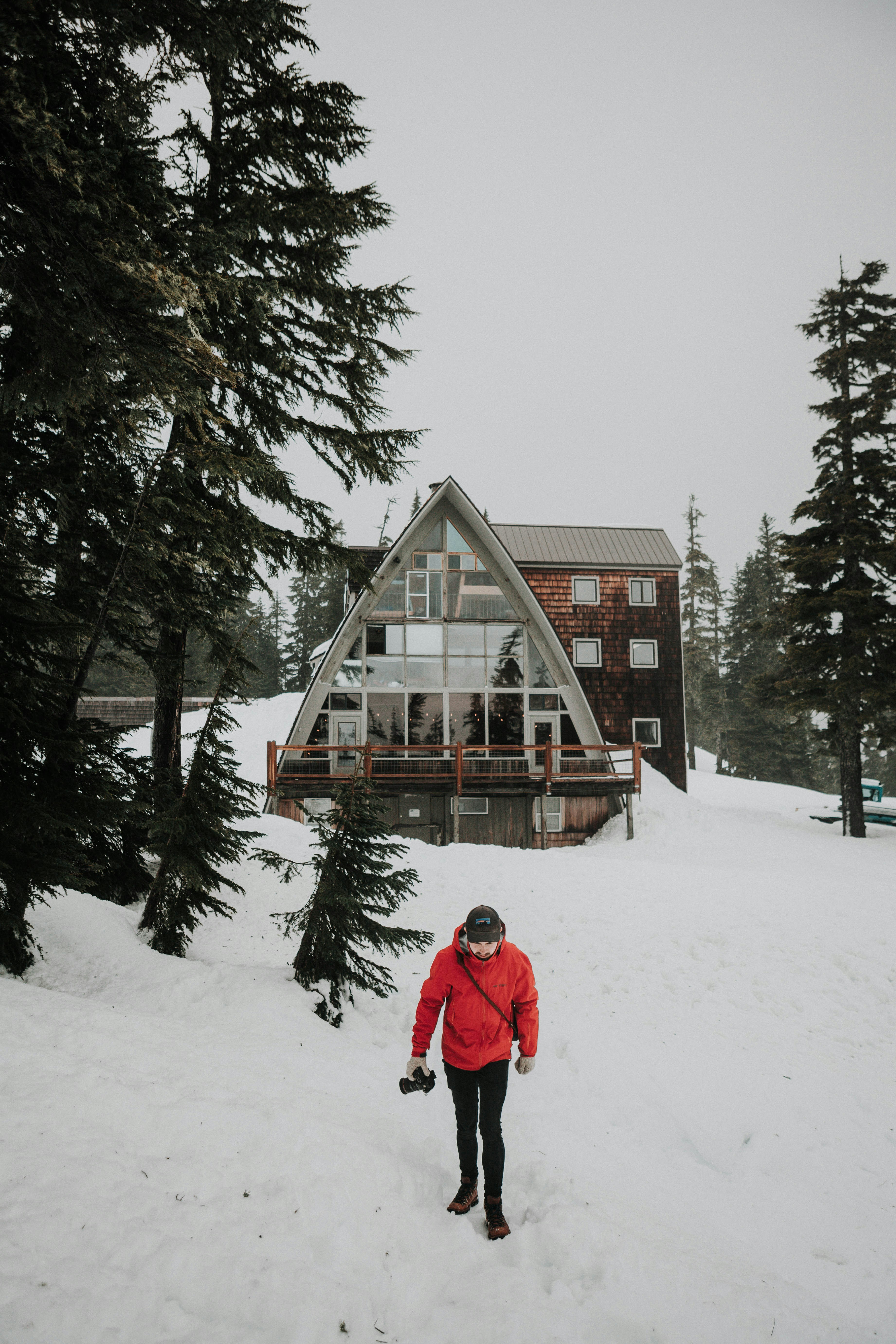 Hiker by Snowy A-Frame Cabin