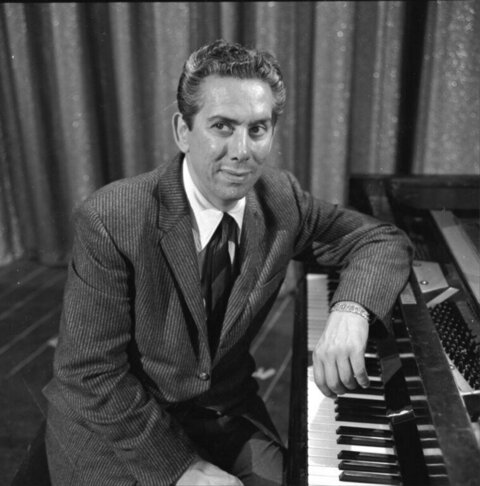 Man Posing Beside Grand Piano