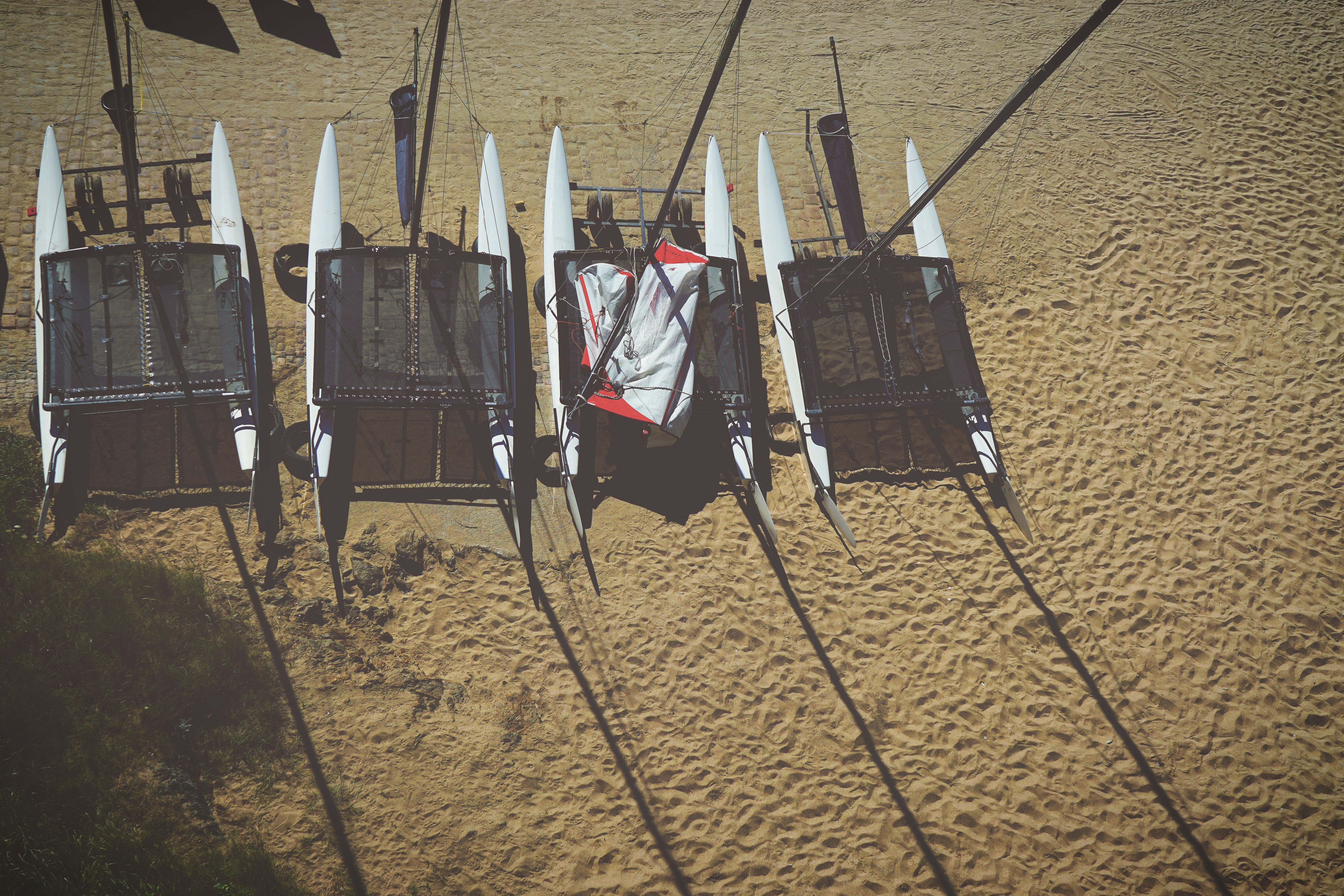 Four Catamarans Parked on Sandy Beach