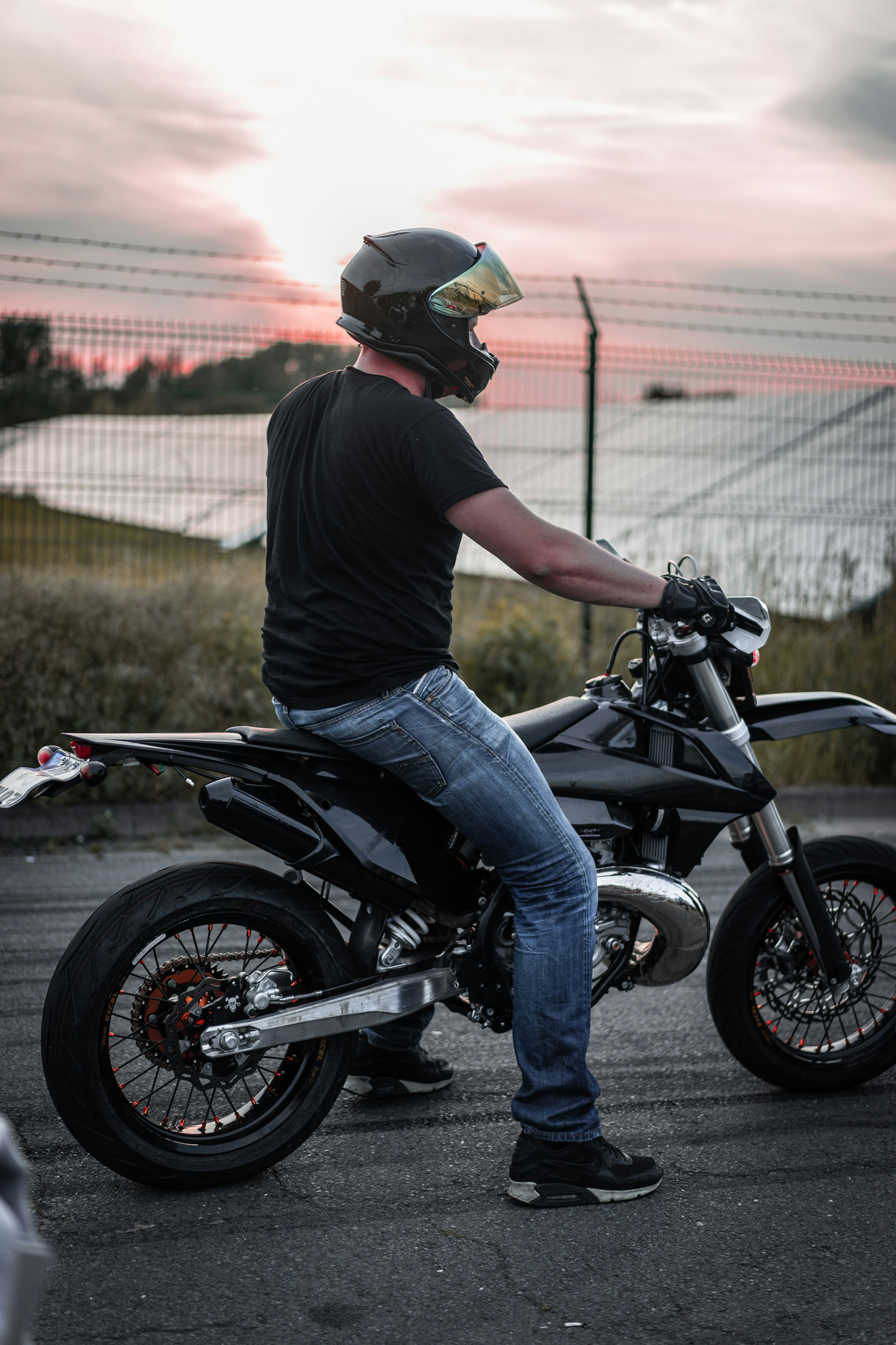Motorcyclist on Black Motorcycle at Sunset