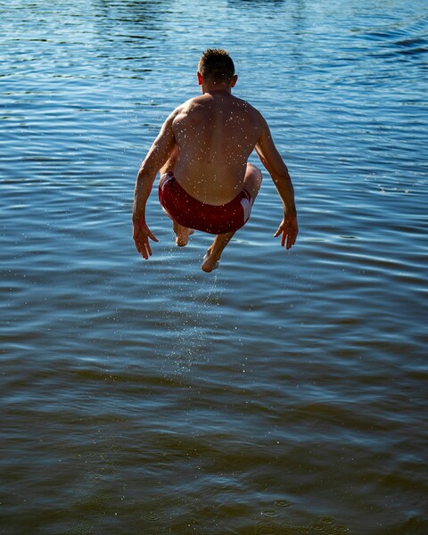 Man Jumping Into Calm Water