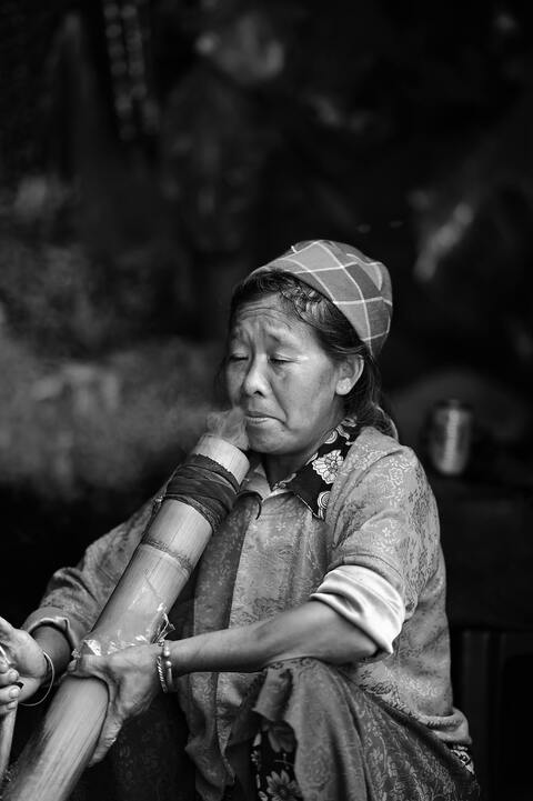 Older Woman Smoking Bamboo Pipe