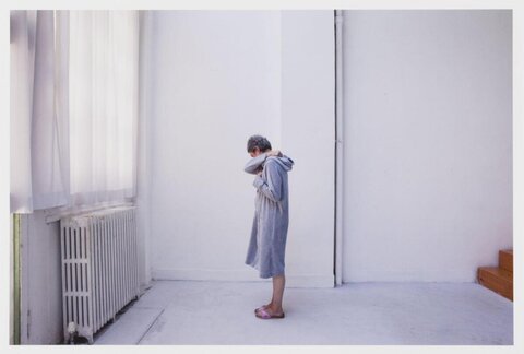Woman Standing Alone In Empty Room