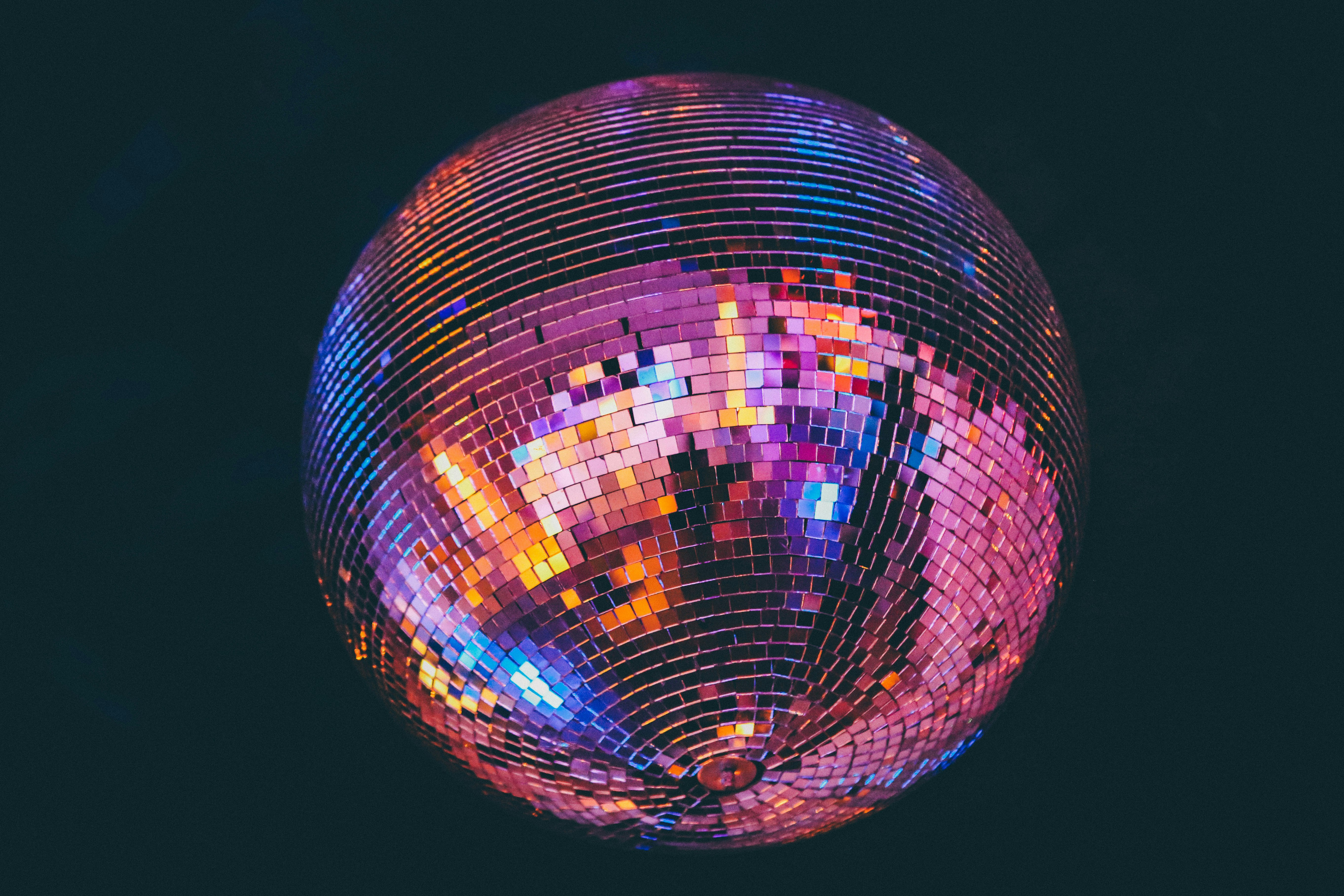 Illuminated Disco Ball Against Dark Background