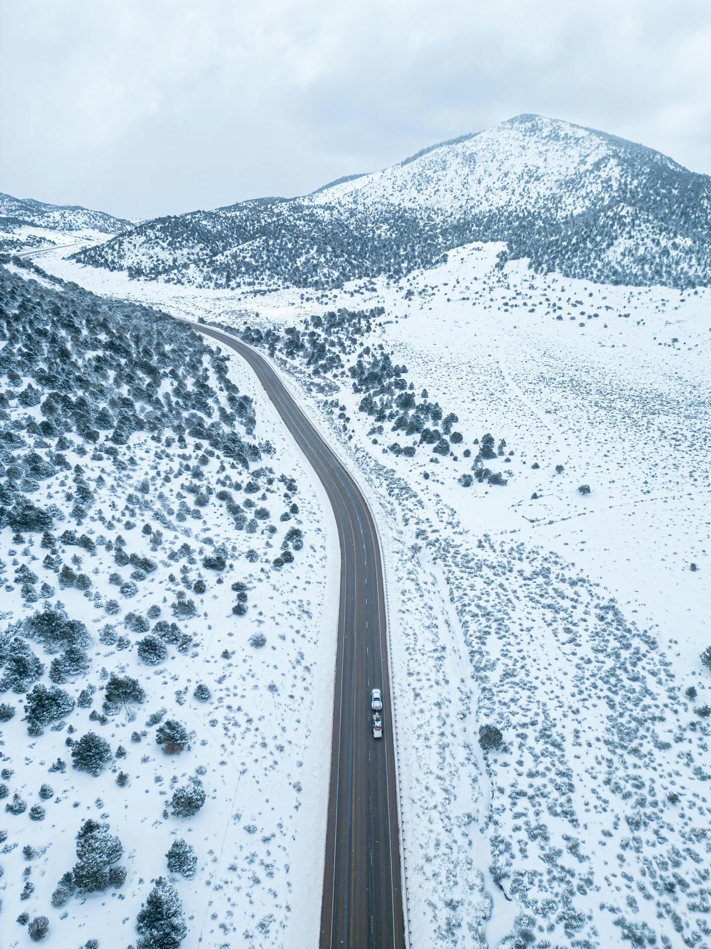 Winding Highway Through Snowy Mountains