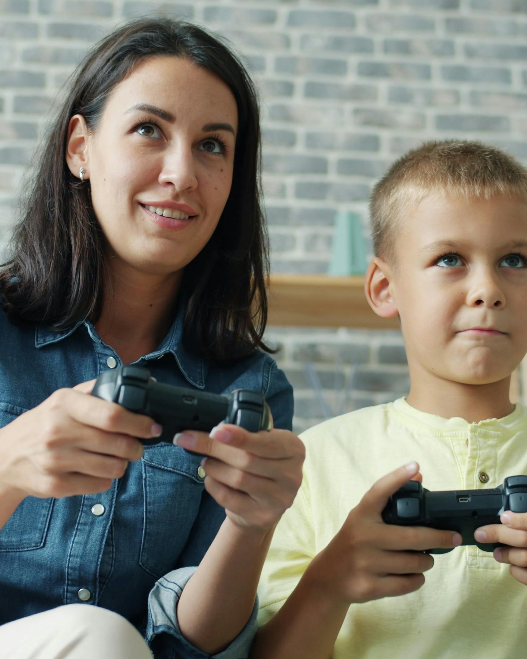 Woman and Boy Playing Video Games — Games