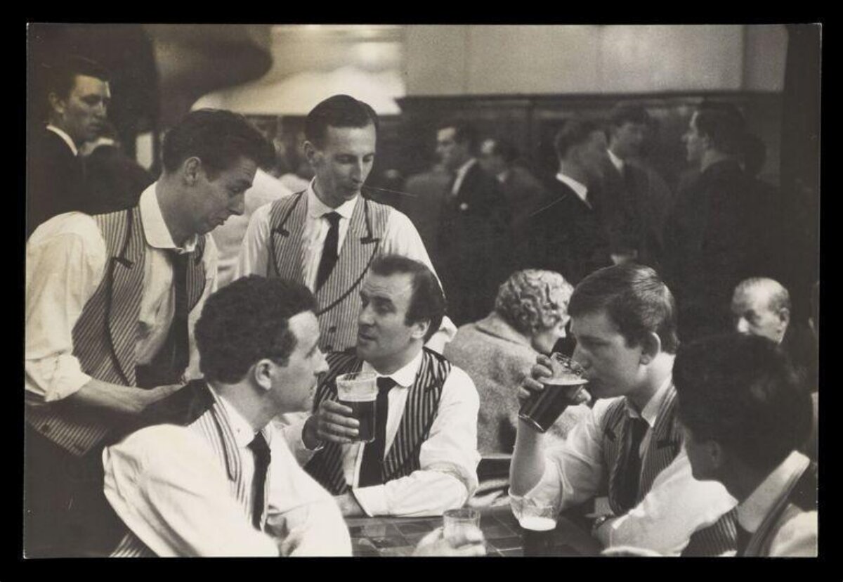 Bartenders Relaxing at Pub Table