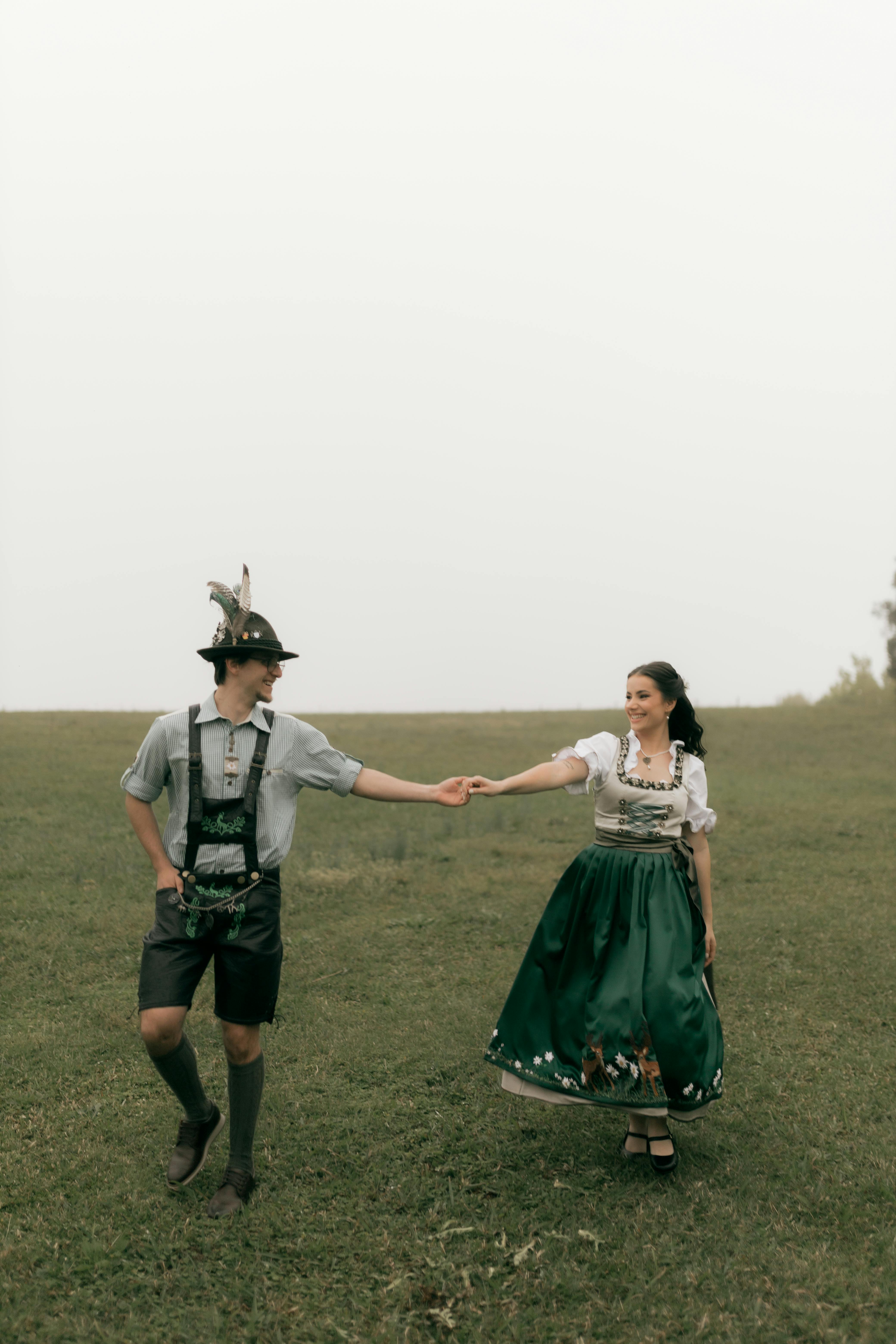 Couple in Traditional Oktoberfest Attire Holding Hands