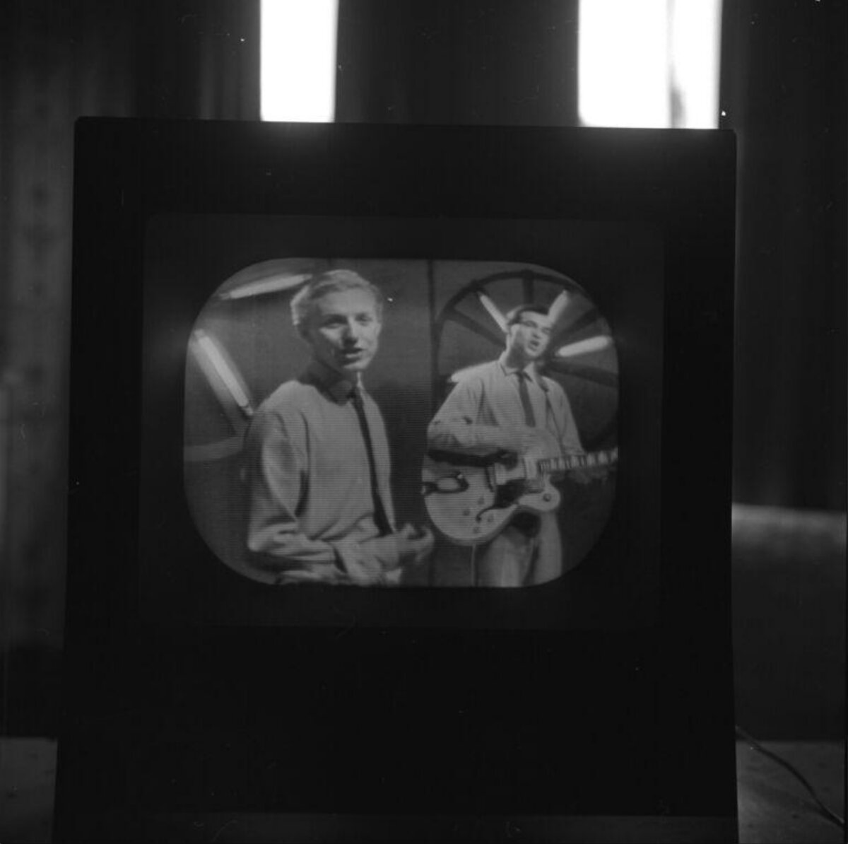 Two Musicians Performing on Old Television