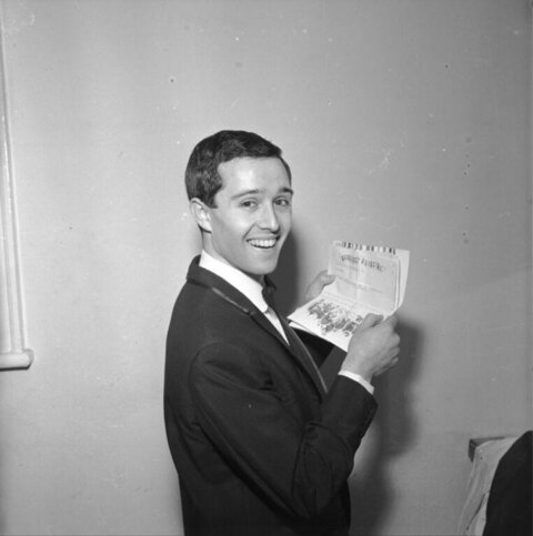 Smiling Man Holding Open Document