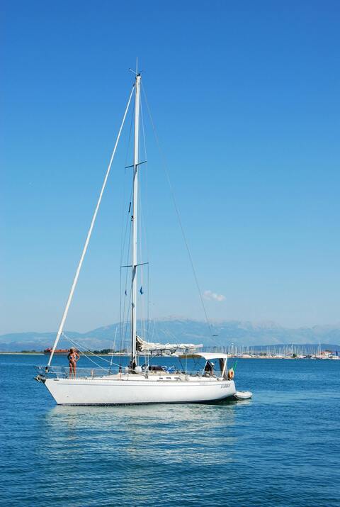 White Sailboat on Calm Blue Sea