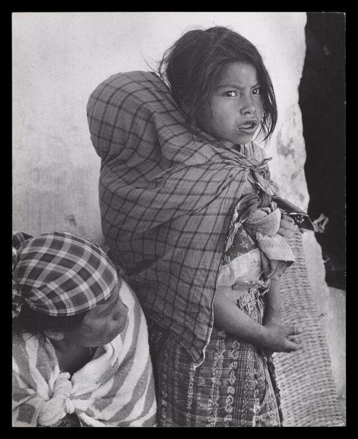 Indigenous Girl Carrying Baby on Back
